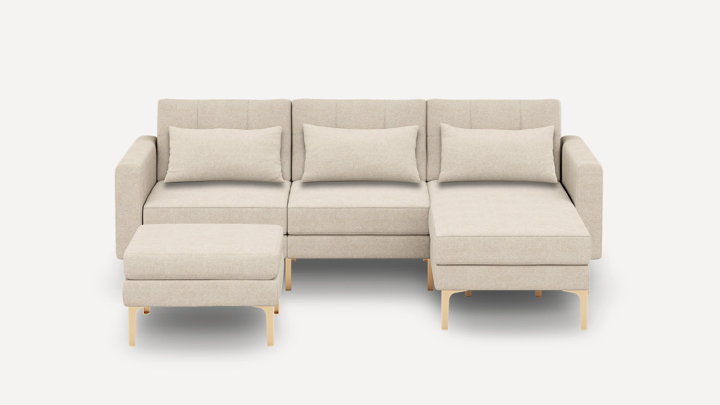 Beige modern sectional sofa with chaise lounge and ottoman, featuring plush cushions and light wooden legs on white background.
