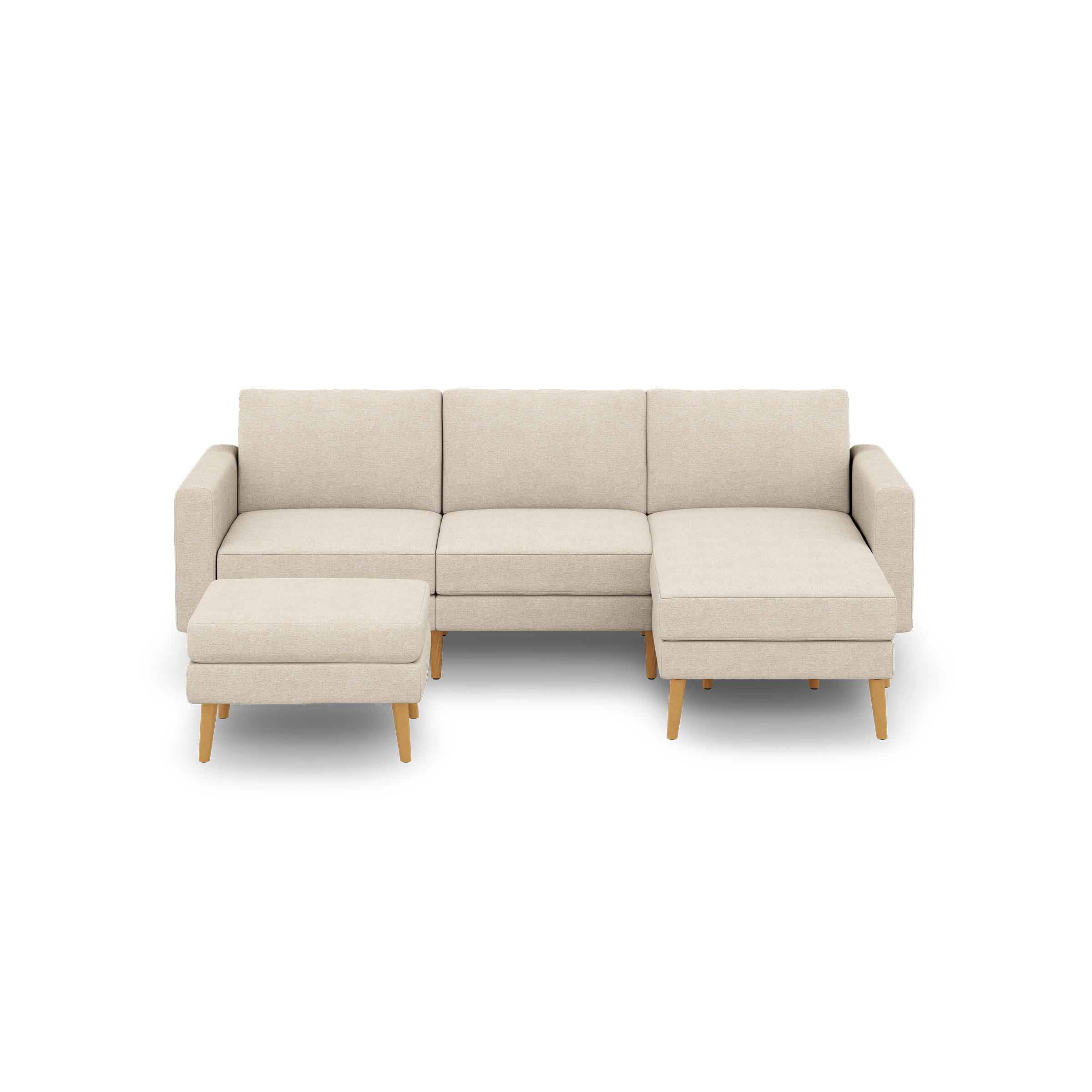 Beige fabric sectional sofa with wooden legs, featuring three seat cushions and a matching ottoman on left side.