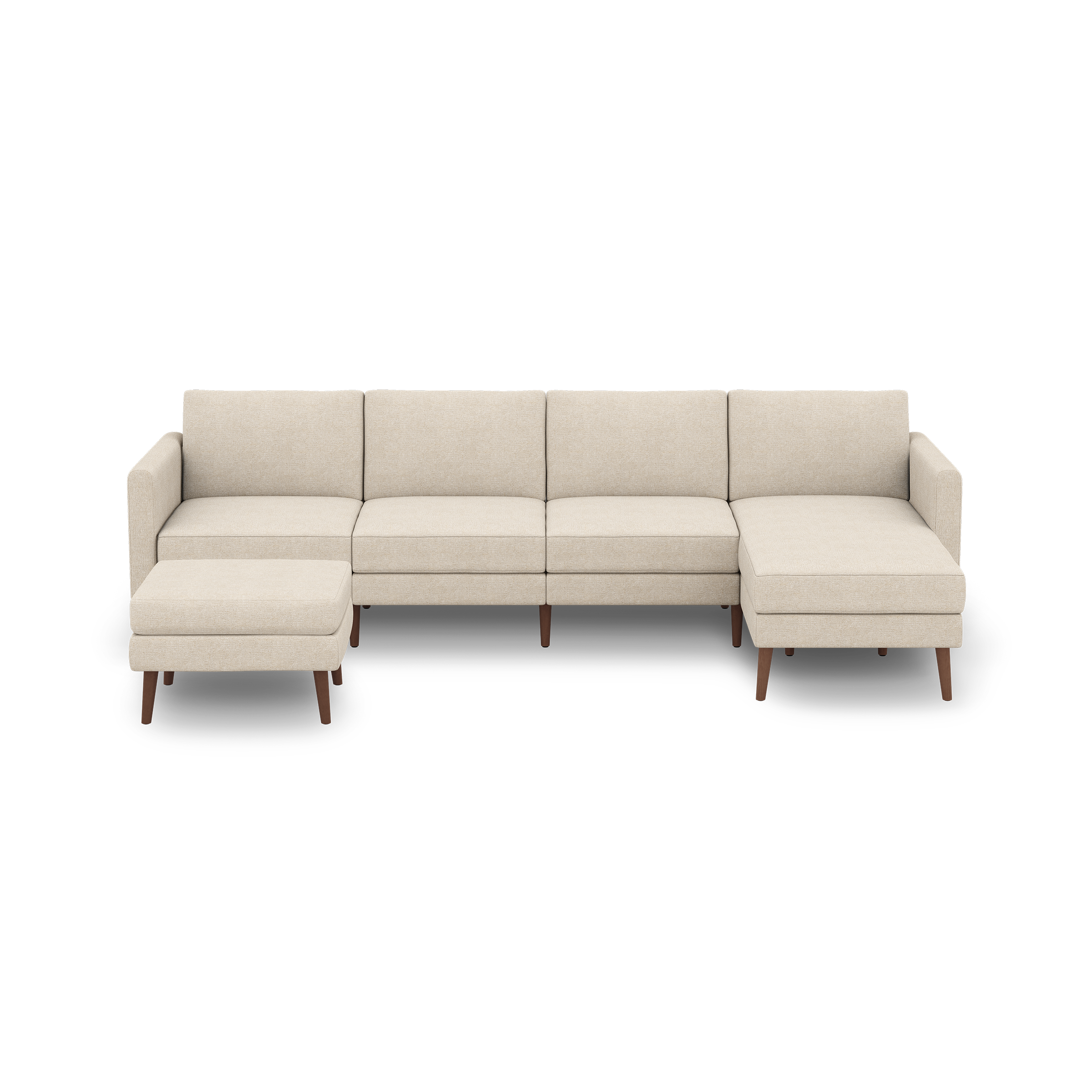 Beige sectional sofa with four seats, wooden legs, and an attached chaise lounge on the right side with an ottoman on the left.