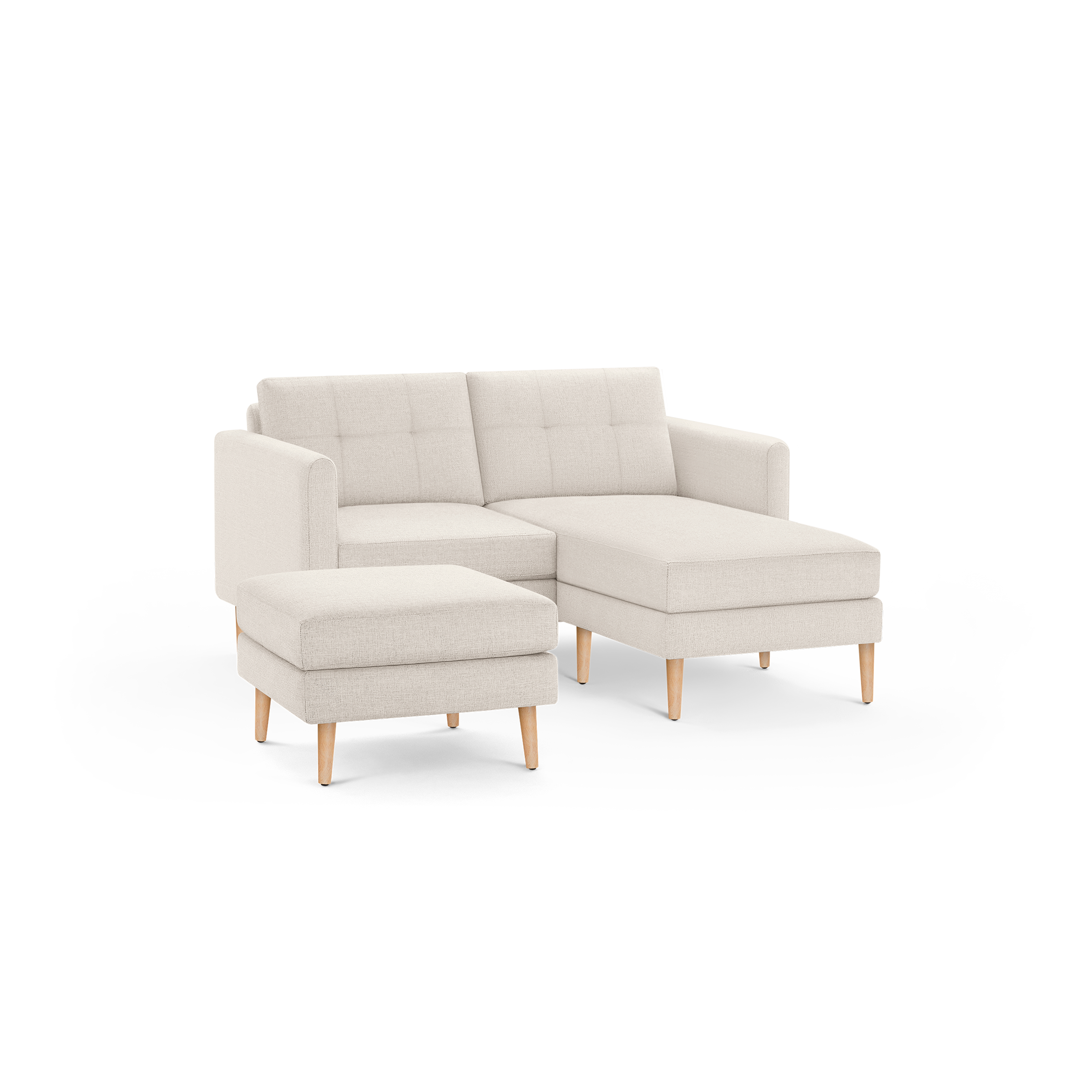 Light beige fabric sectional sofa with tufted back cushions, wooden legs, and matching ottoman on black background.