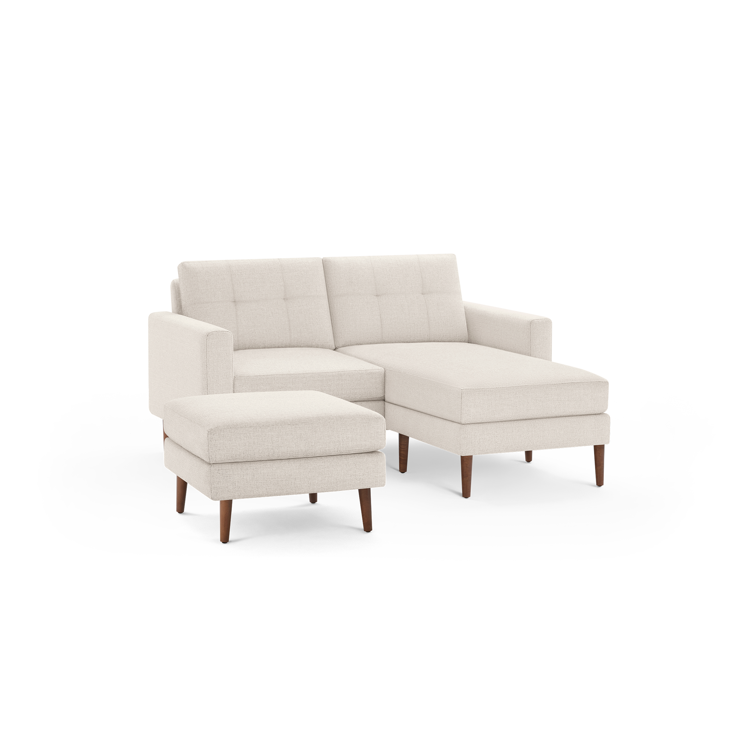 Beige fabric sectional sofa with tufted back cushions, straight arms, wooden legs, and a matching ottoman.