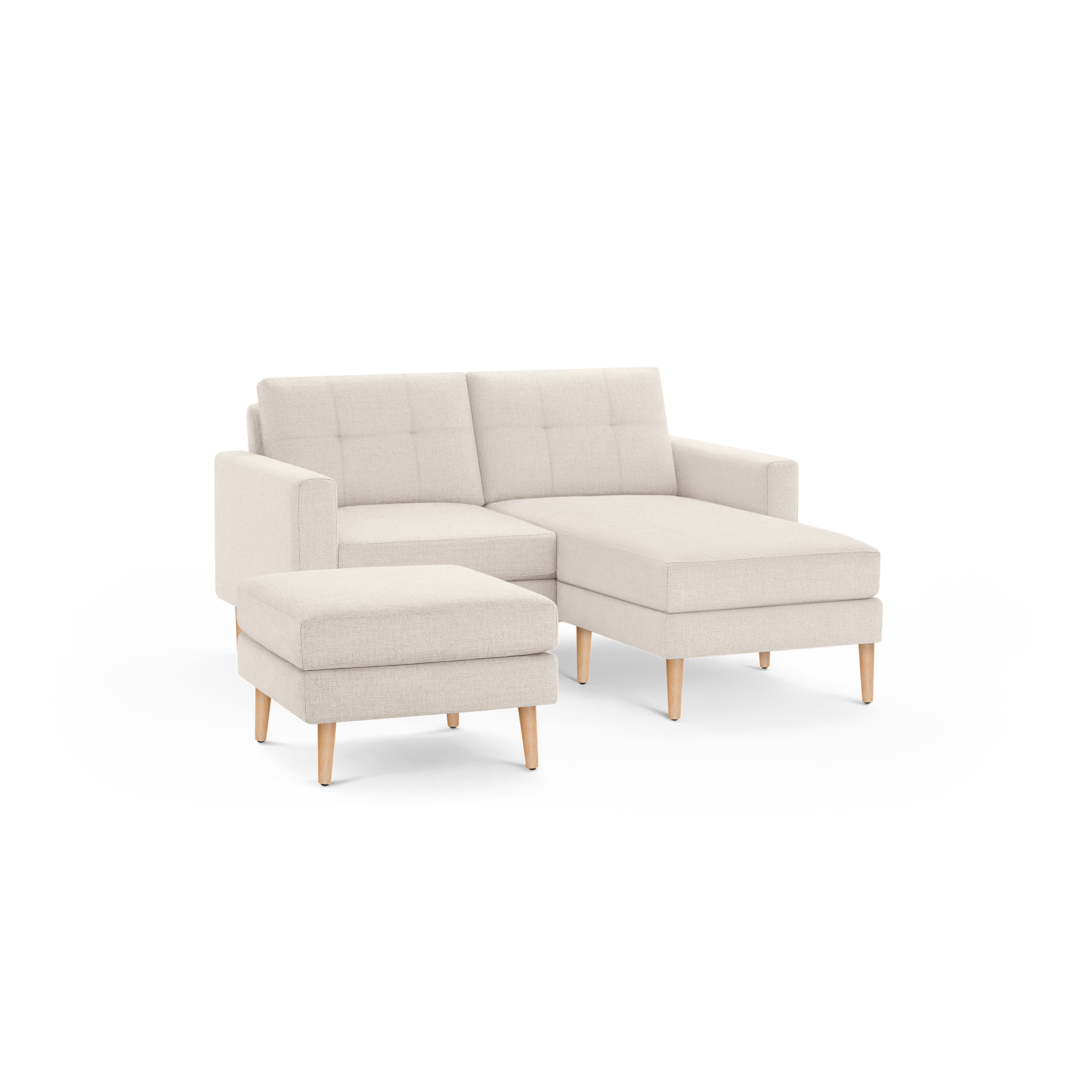 Light beige modern sectional sofa with tufted back cushions, wooden legs, and a matching ottoman.
