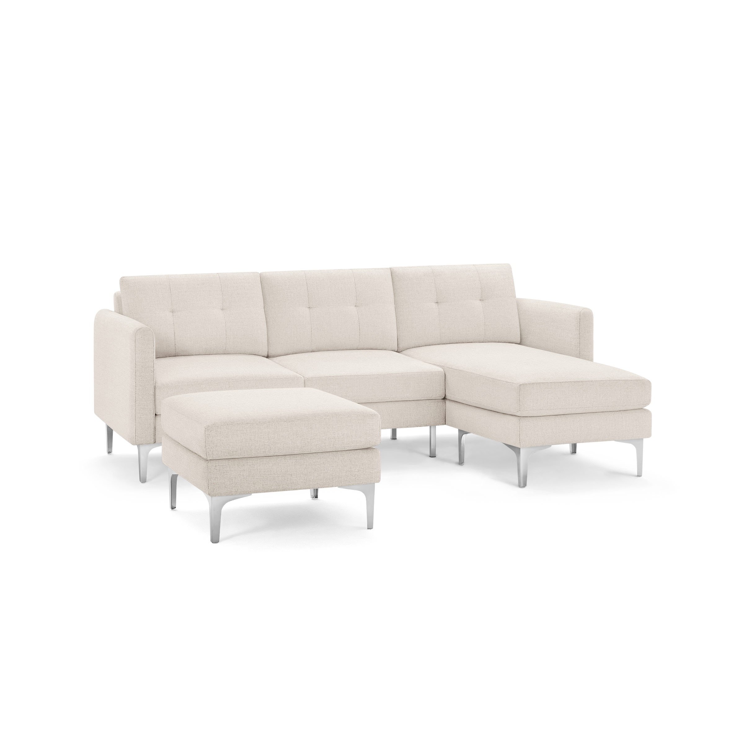 Light beige modern sectional sofa with tufted back cushions, chaise lounge on the right side, and matching ottoman with metal legs.