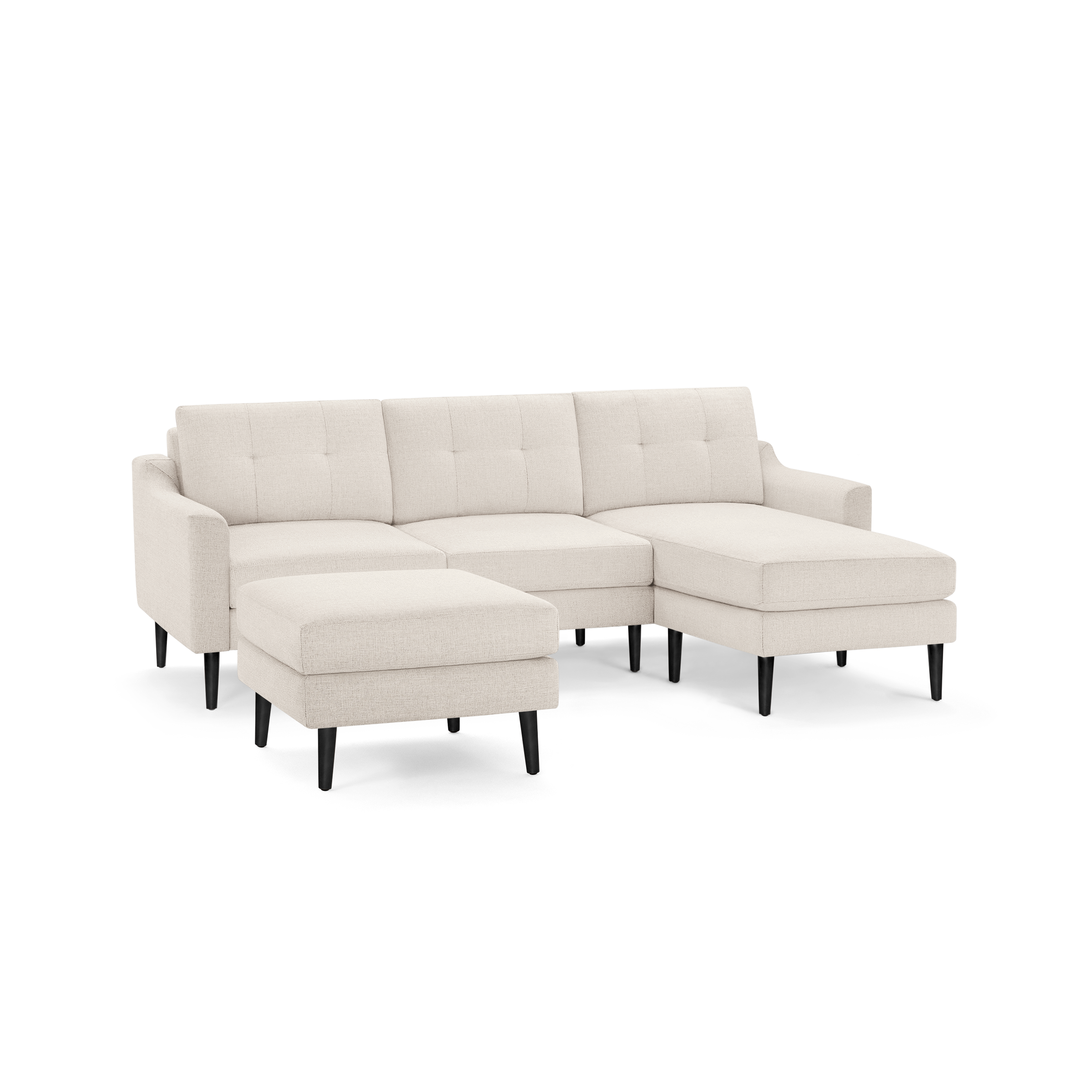 Beige fabric sectional sofa with tufted back cushions, left chaise, and separate ottoman on black wooden legs.