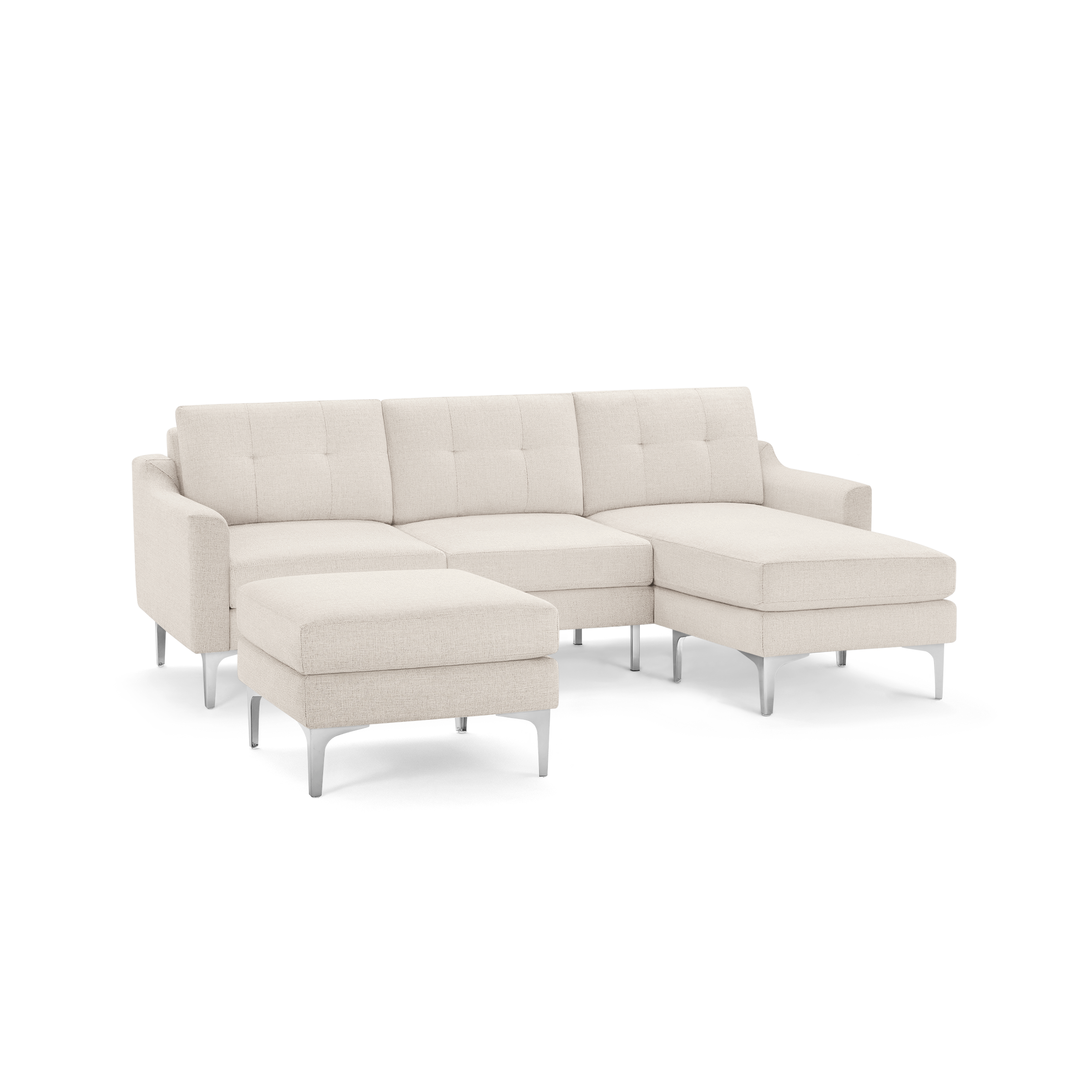 Beige upholstered sectional sofa with tufted cushions, slim armrests, metal legs, and a matching ottoman.