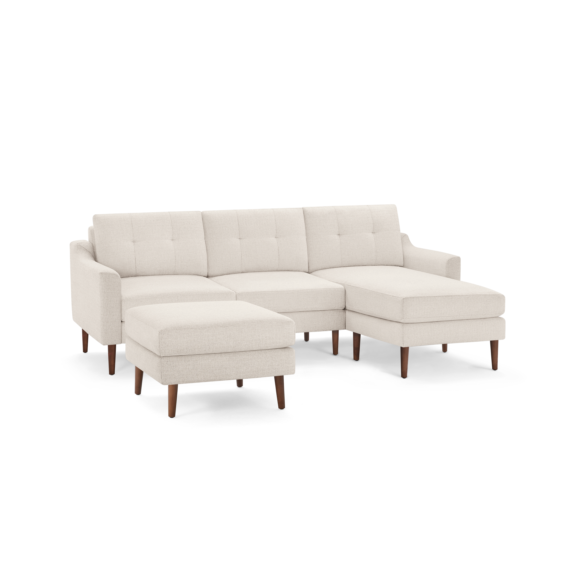 Beige L-shaped sectional sofa with tufted back cushions and wooden legs, including a matching ottoman.