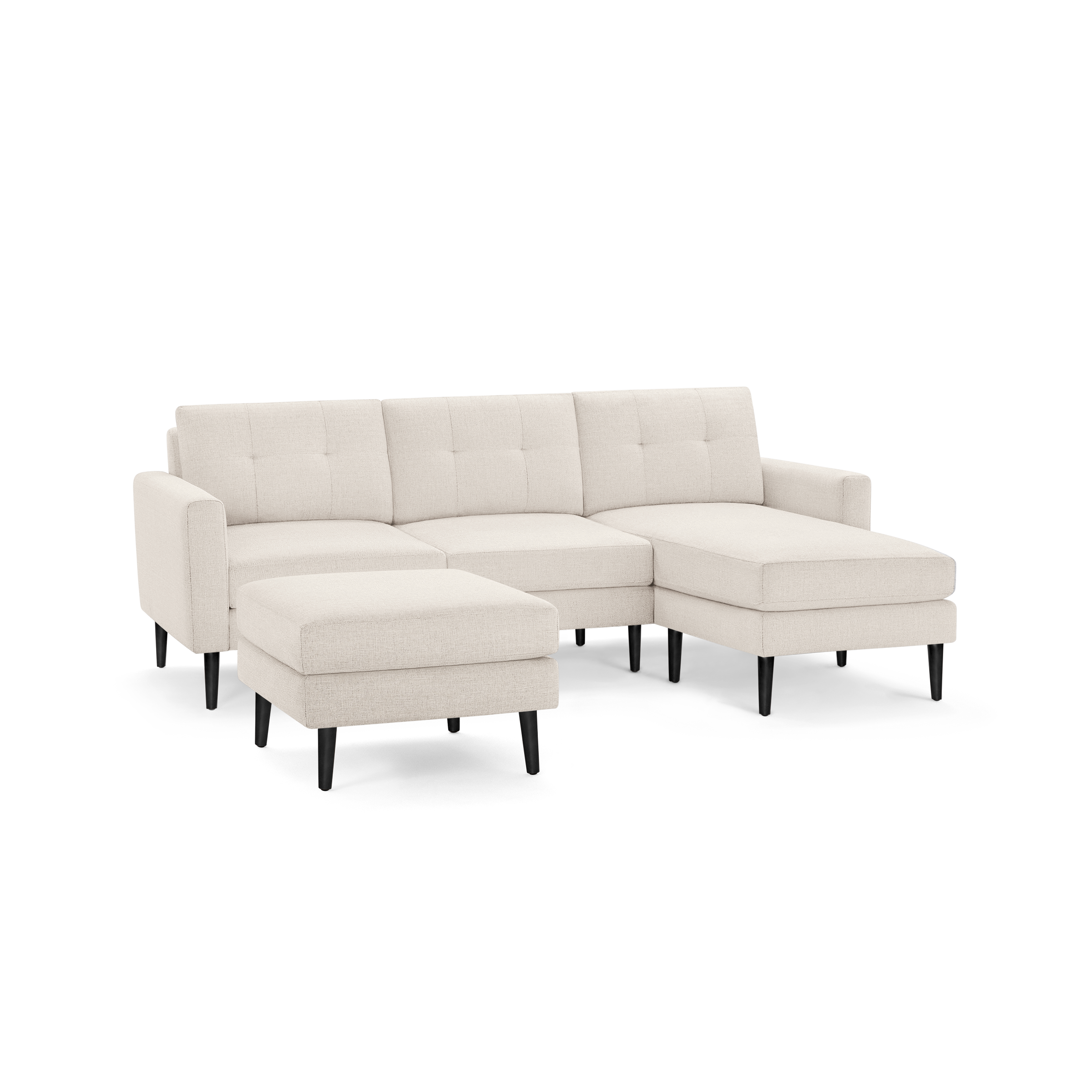 Modern beige sectional sofa with tufted back cushions, sleek black tapered legs, and matching ottoman.