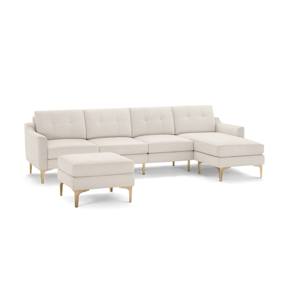 Modern beige sectional sofa with tufted cushions, gold metal legs, and a matching ottoman, perfect for spacious living rooms.