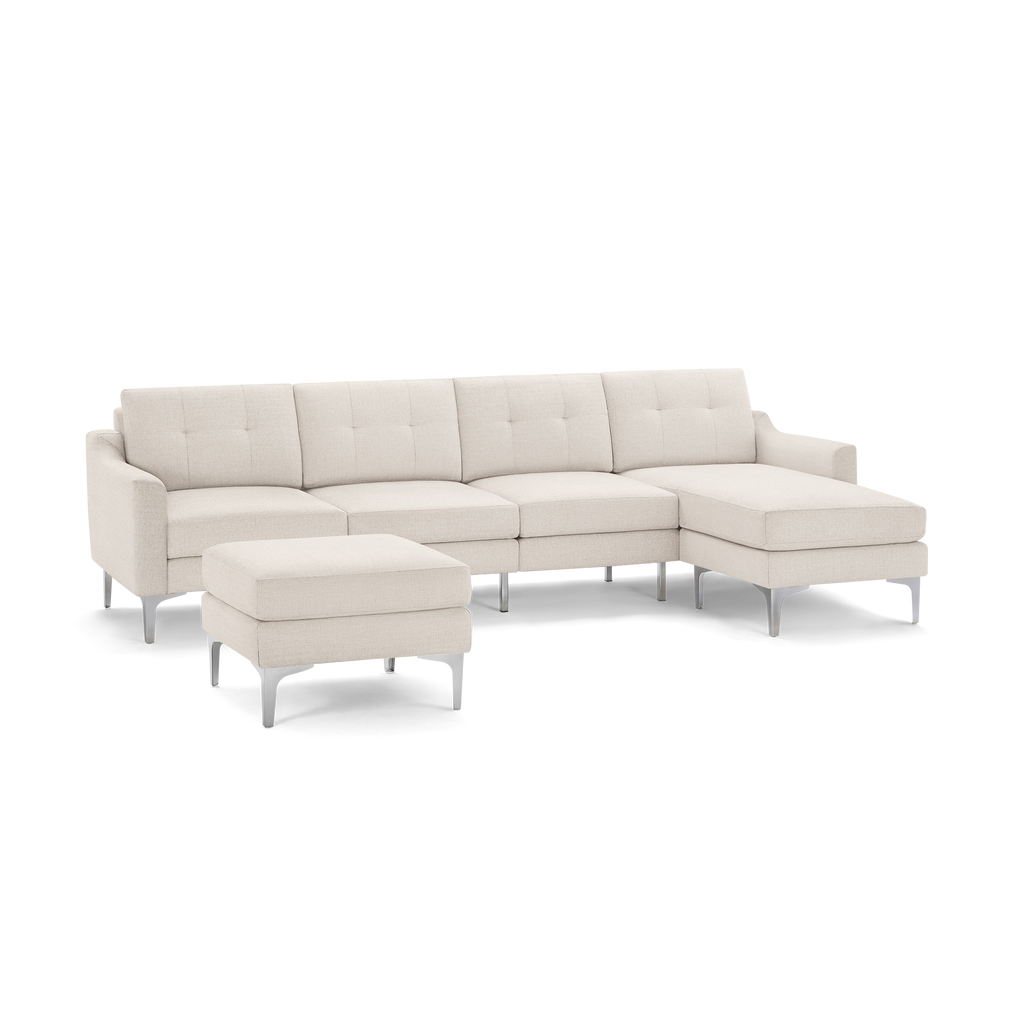 Modern beige fabric sectional sofa with tufted back cushions, metal legs, and a matching ottoman.