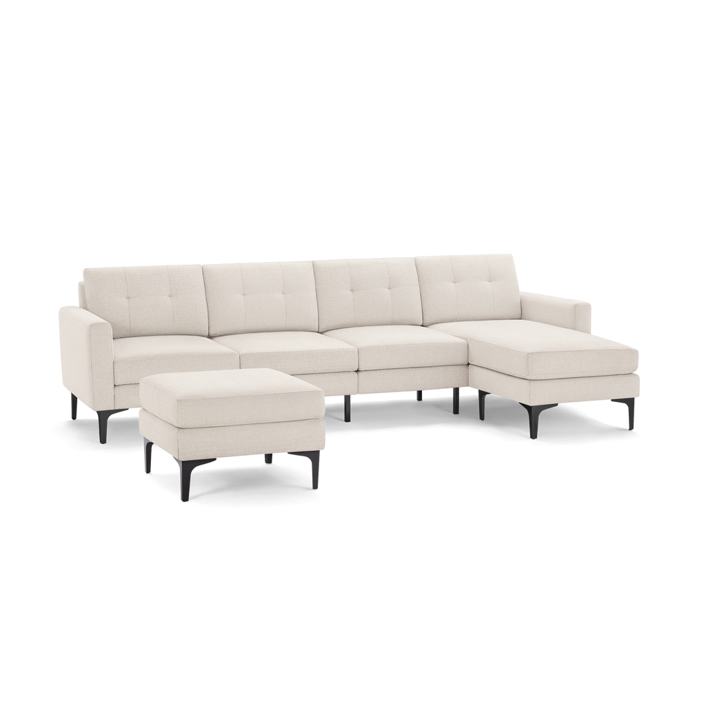 Modern beige fabric sectional sofa with tufted back cushions, right chaise, and matching ottoman on black tapered legs.