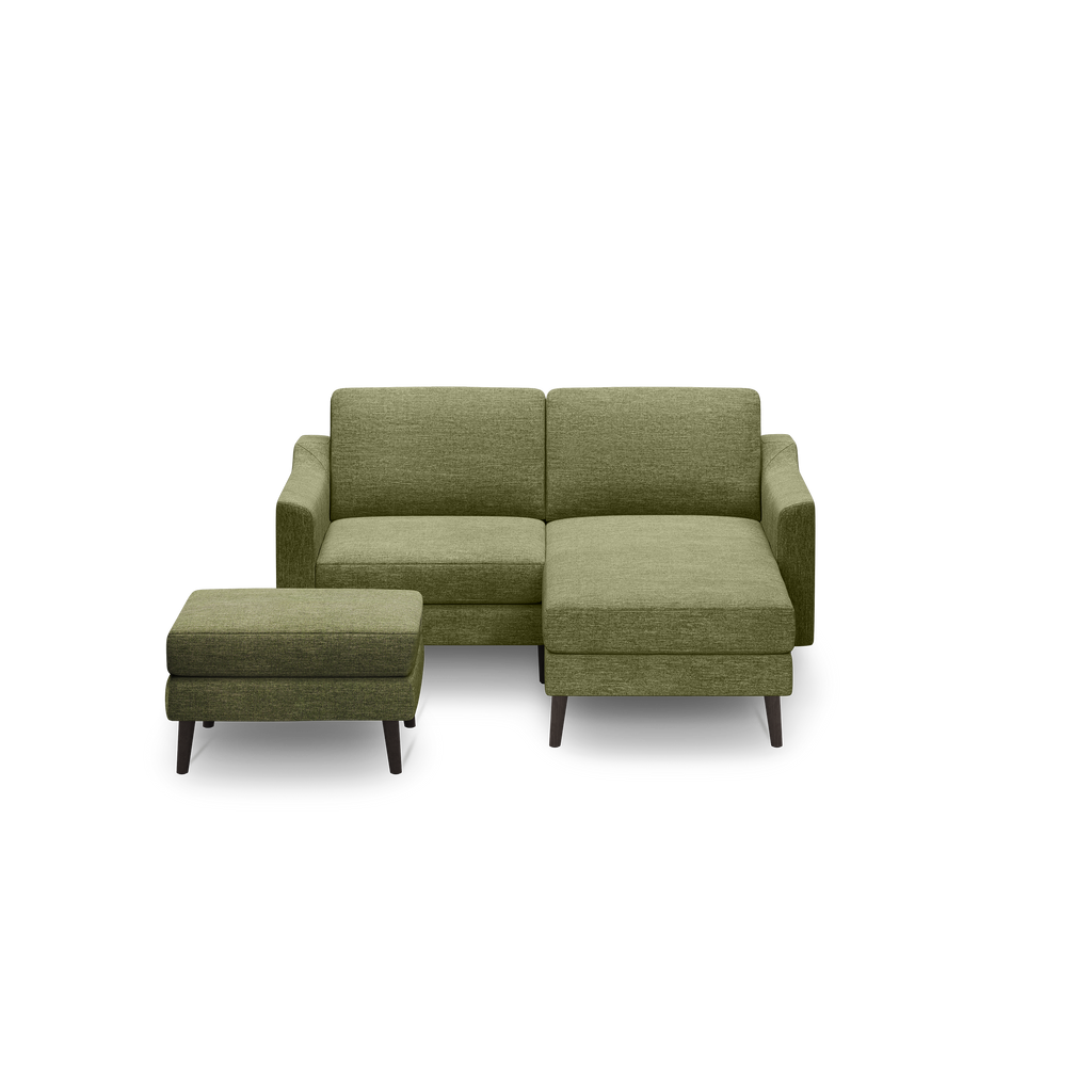 Modern olive green fabric sectional sofa with right chaise and matching rectangular ottoman, featuring dark tapered wooden legs.