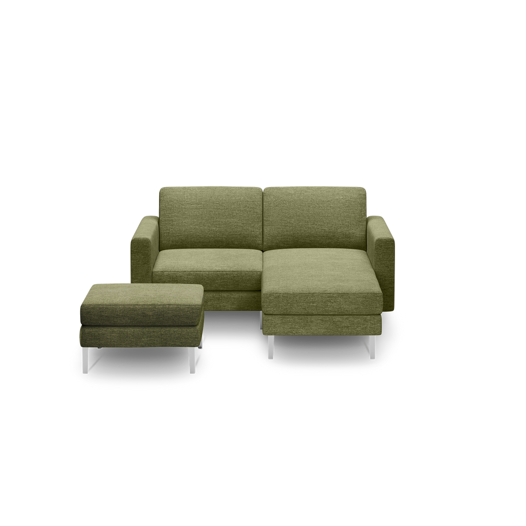 Modern olive green sectional sofa with chaise lounge and matching ottoman, featuring sleek silver legs.