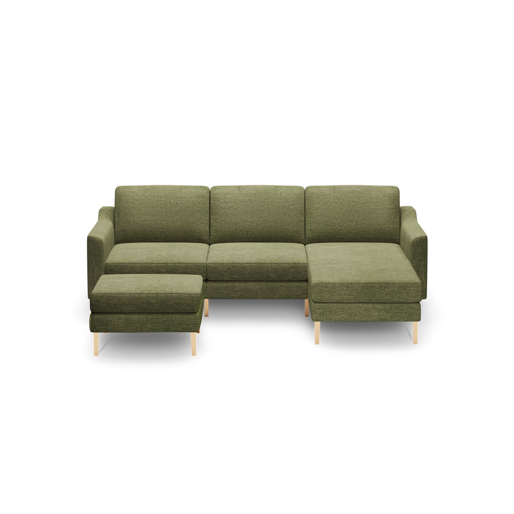 Green fabric sectional sofa with wooden legs, featuring a left-side ottoman and right-side chaise lounge.