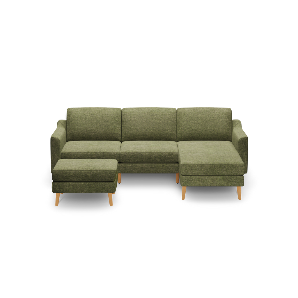 Modern olive green fabric sectional sofa with wooden legs, featuring a chaise lounge on the right and a matching ottoman on the left.