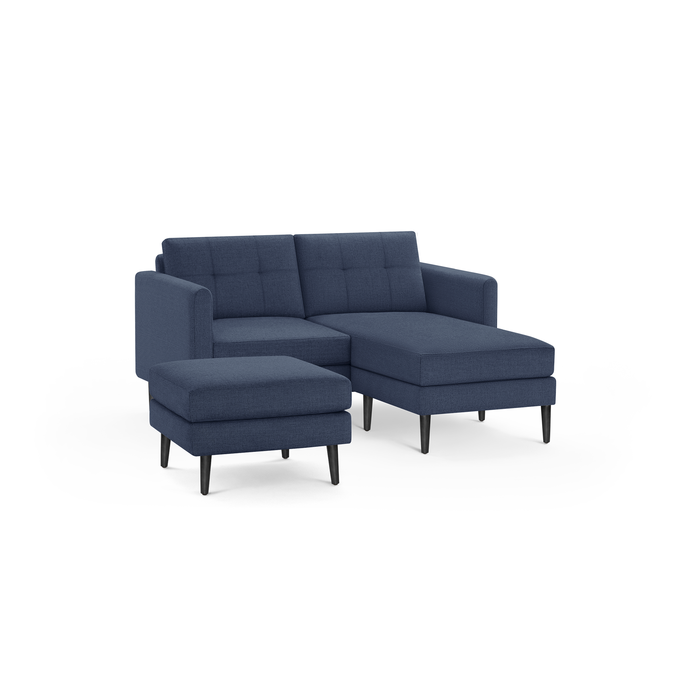 Modern navy blue fabric sectional sofa with tufted back cushions, chaise lounge, and matching ottoman on black tapered legs.