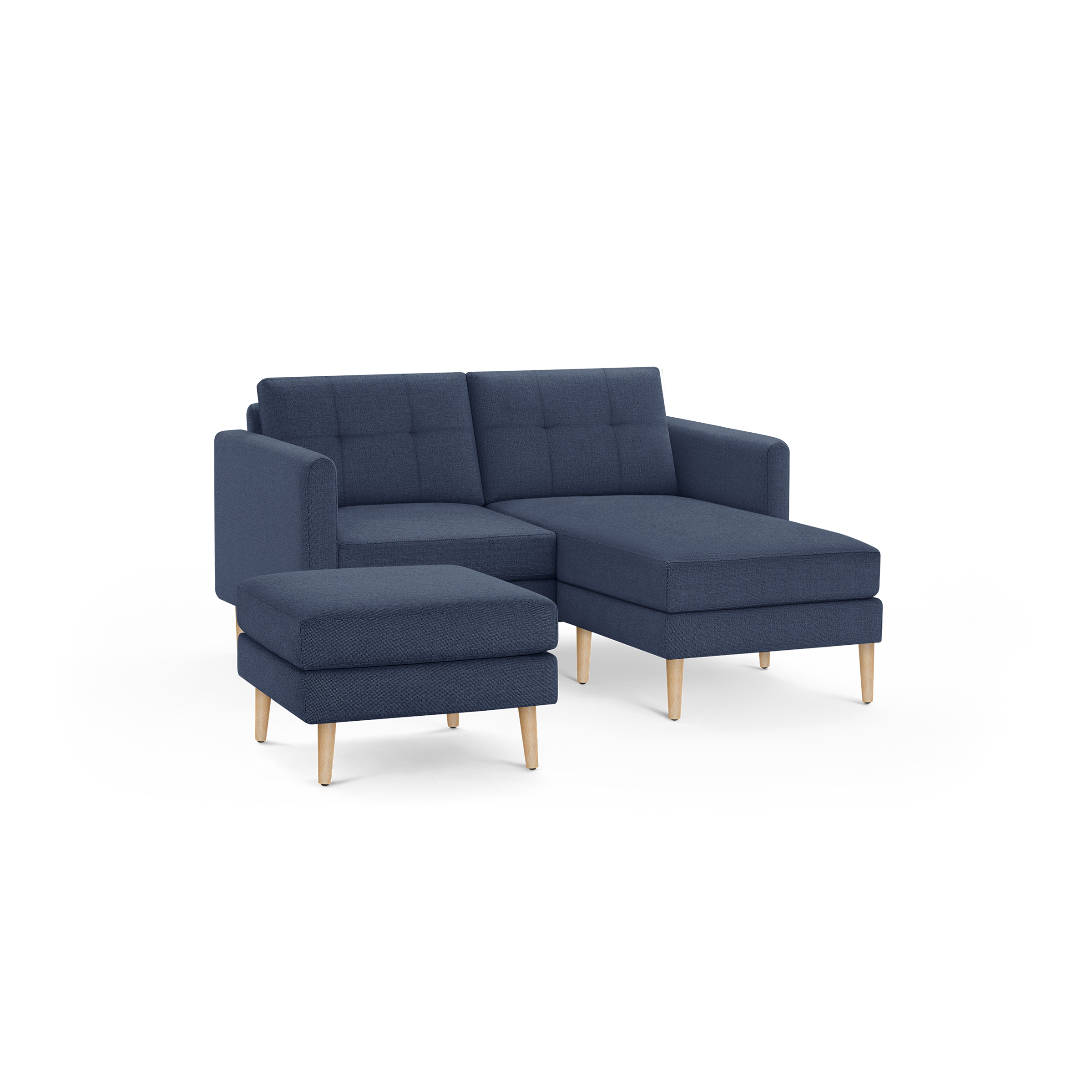 Modern navy blue fabric sectional sofa with tufted back cushions and light wooden legs, including a matching ottoman.