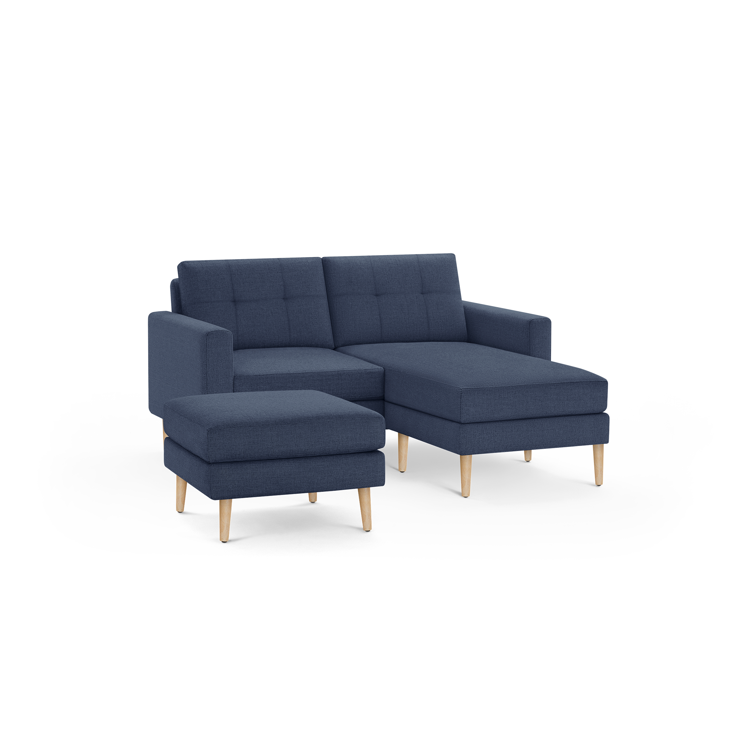 Modern navy blue fabric sectional sofa with tufted back cushions and matching ottoman, supported by wooden legs.