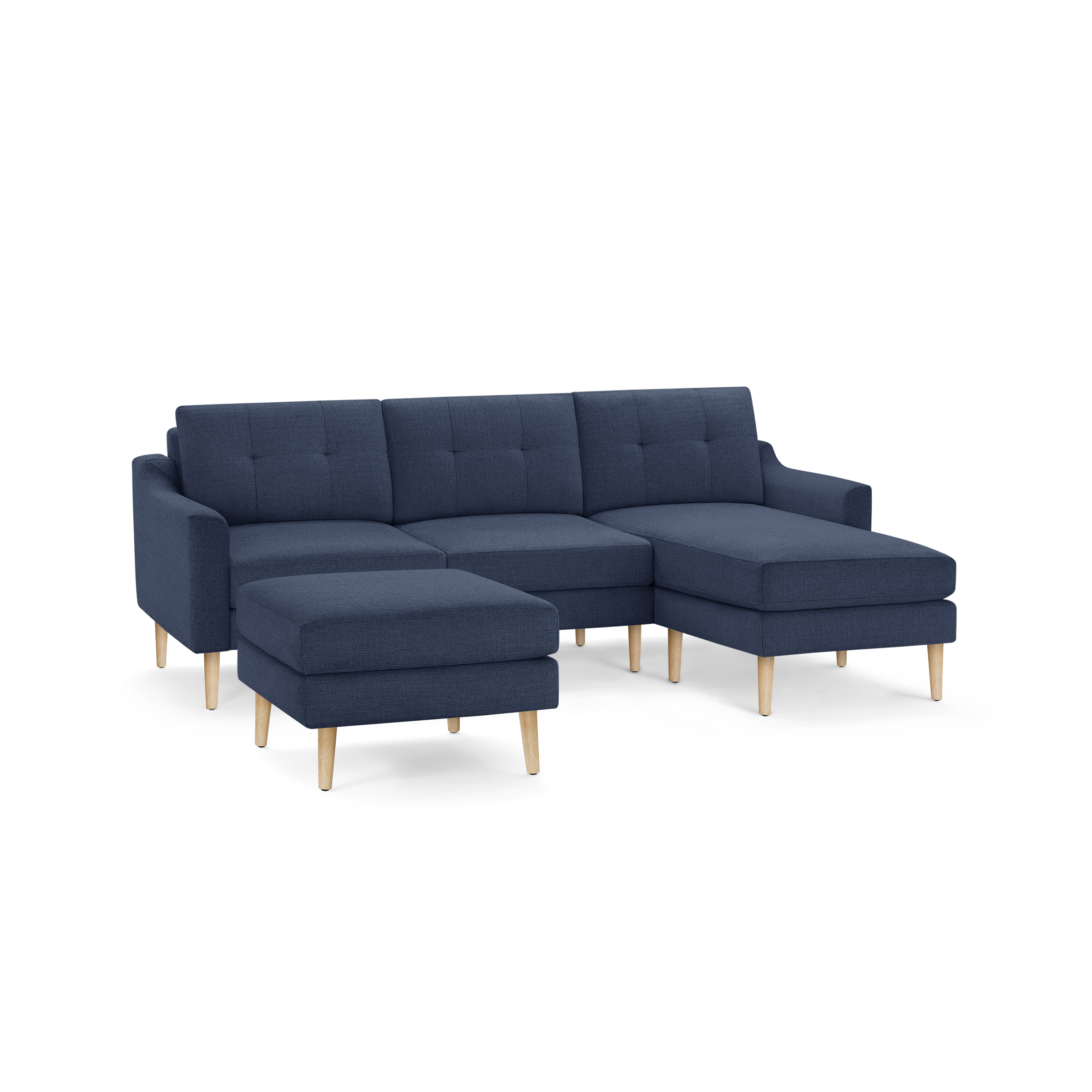 Modern navy blue fabric sectional sofa with wooden legs, tufted back cushions, and separate matching ottoman.