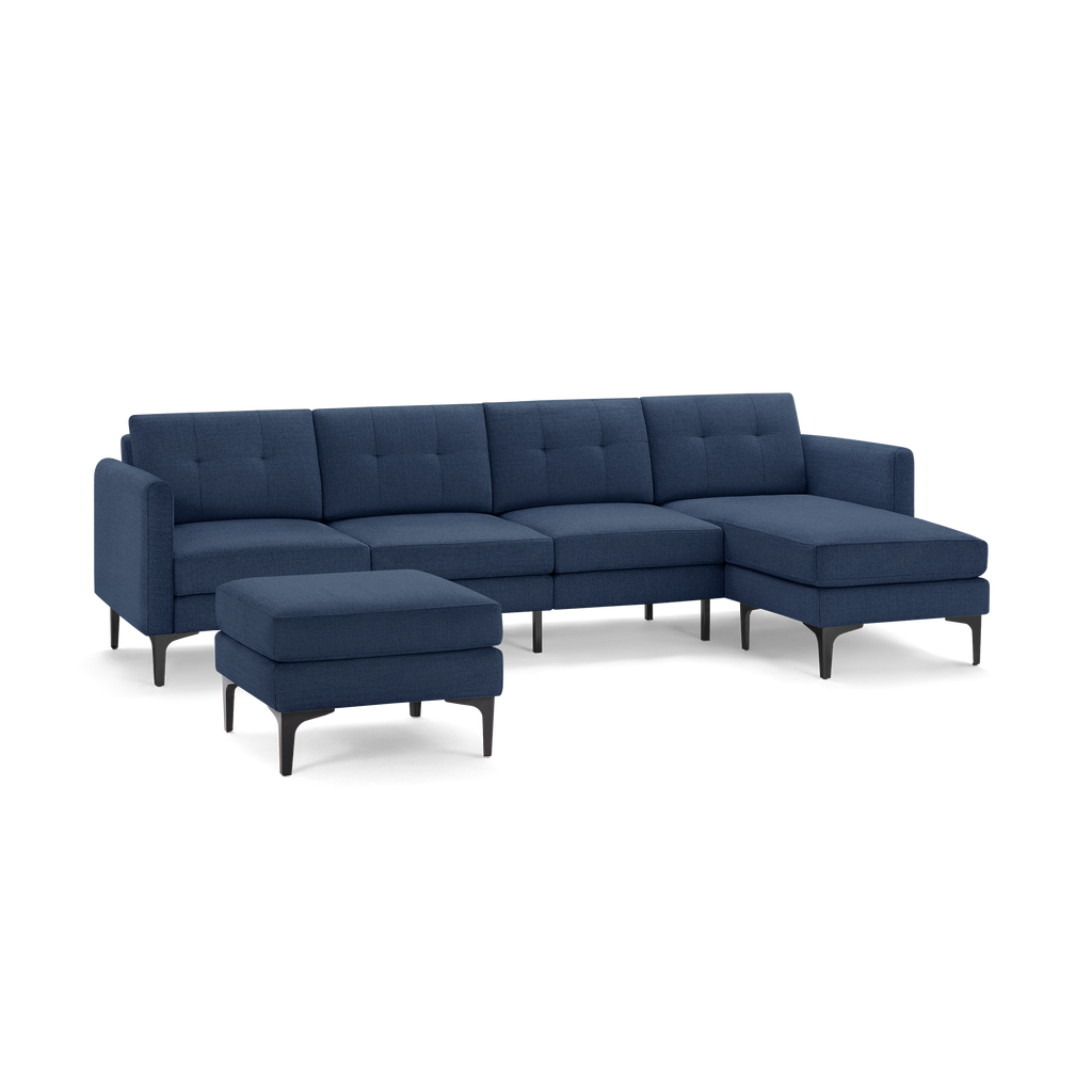 Modern navy blue fabric sectional sofa with tufted back cushions, black metal legs, and matching upholstered ottoman.