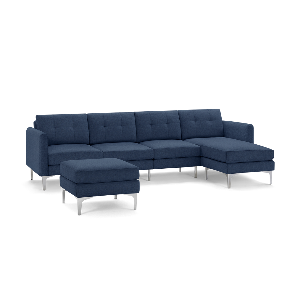 Modern navy blue sectional sofa with metal legs, featuring a chaise lounge and matching ottoman, upholstered in textured fabric.