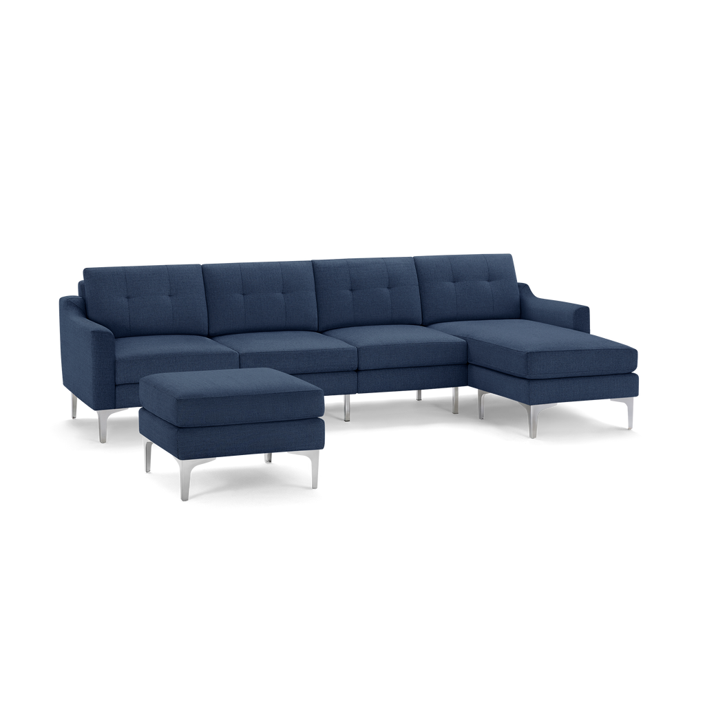 Modern navy blue sectional sofa with tufted cushions, metal legs, and a matching ottoman, designed for living room comfort and style.