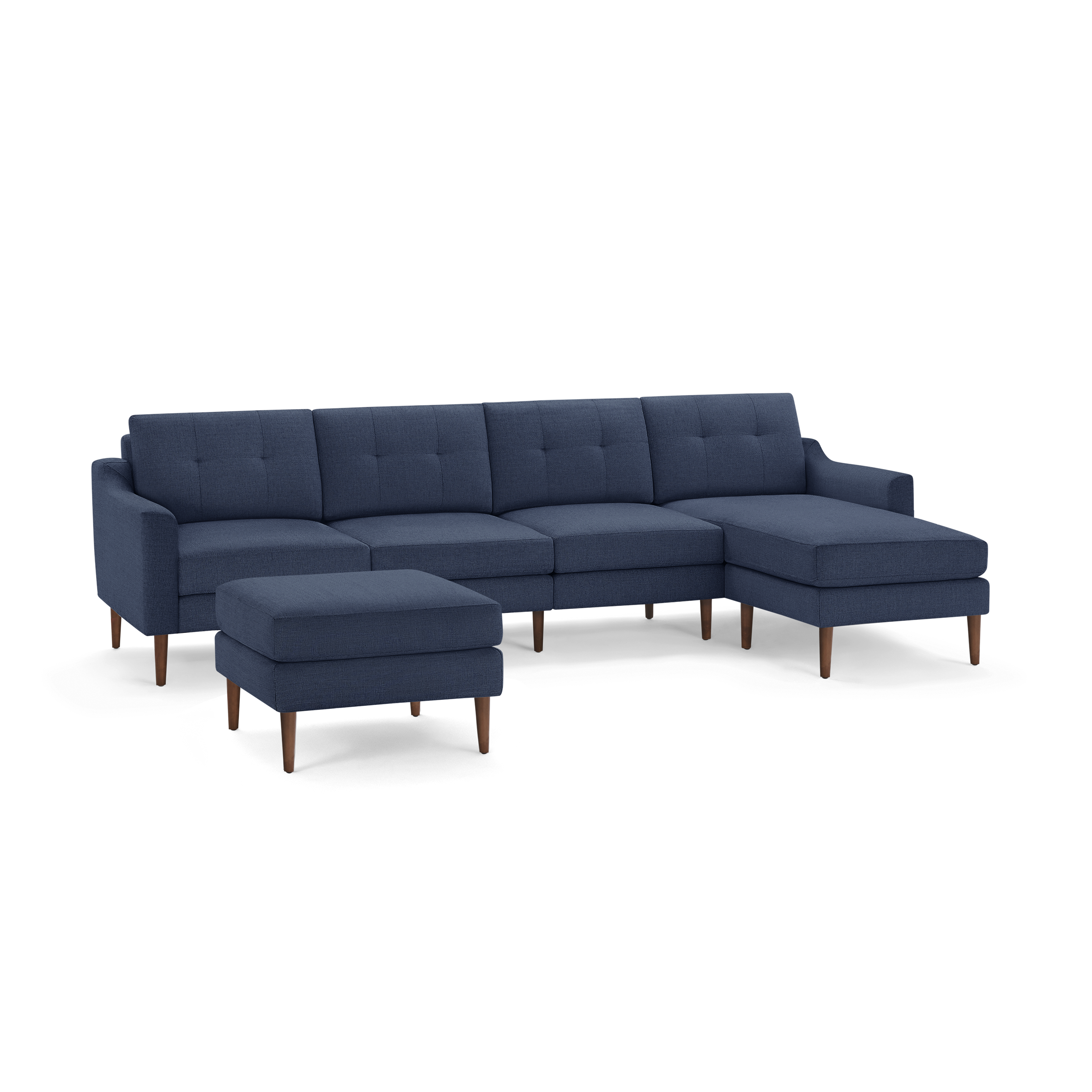 Mid-century modern navy blue sectional sofa with button-tufted cushions, wooden legs, and a matching ottoman.