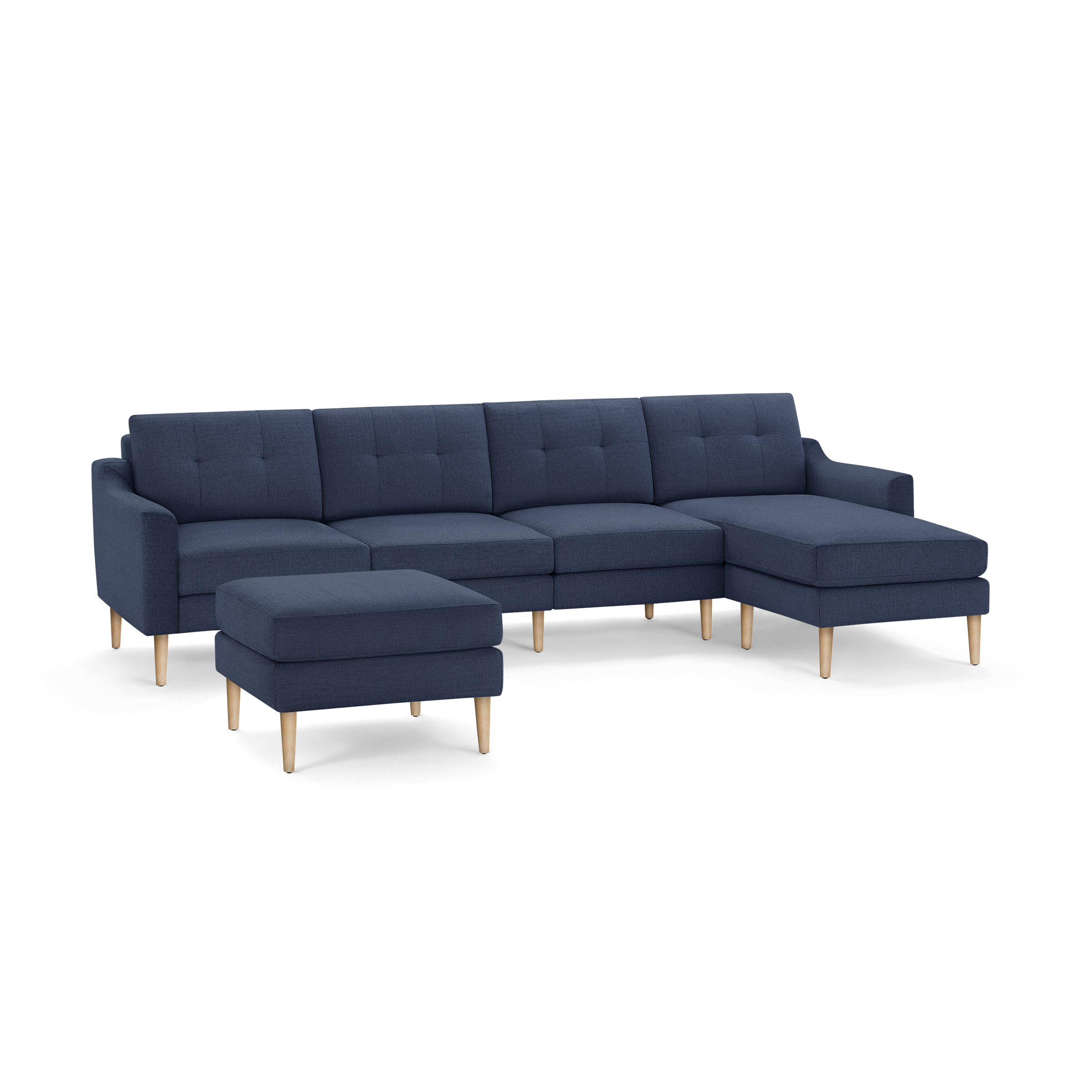 Modern navy blue sectional sofa with wooden legs, featuring tufted cushions and a matching ottoman.