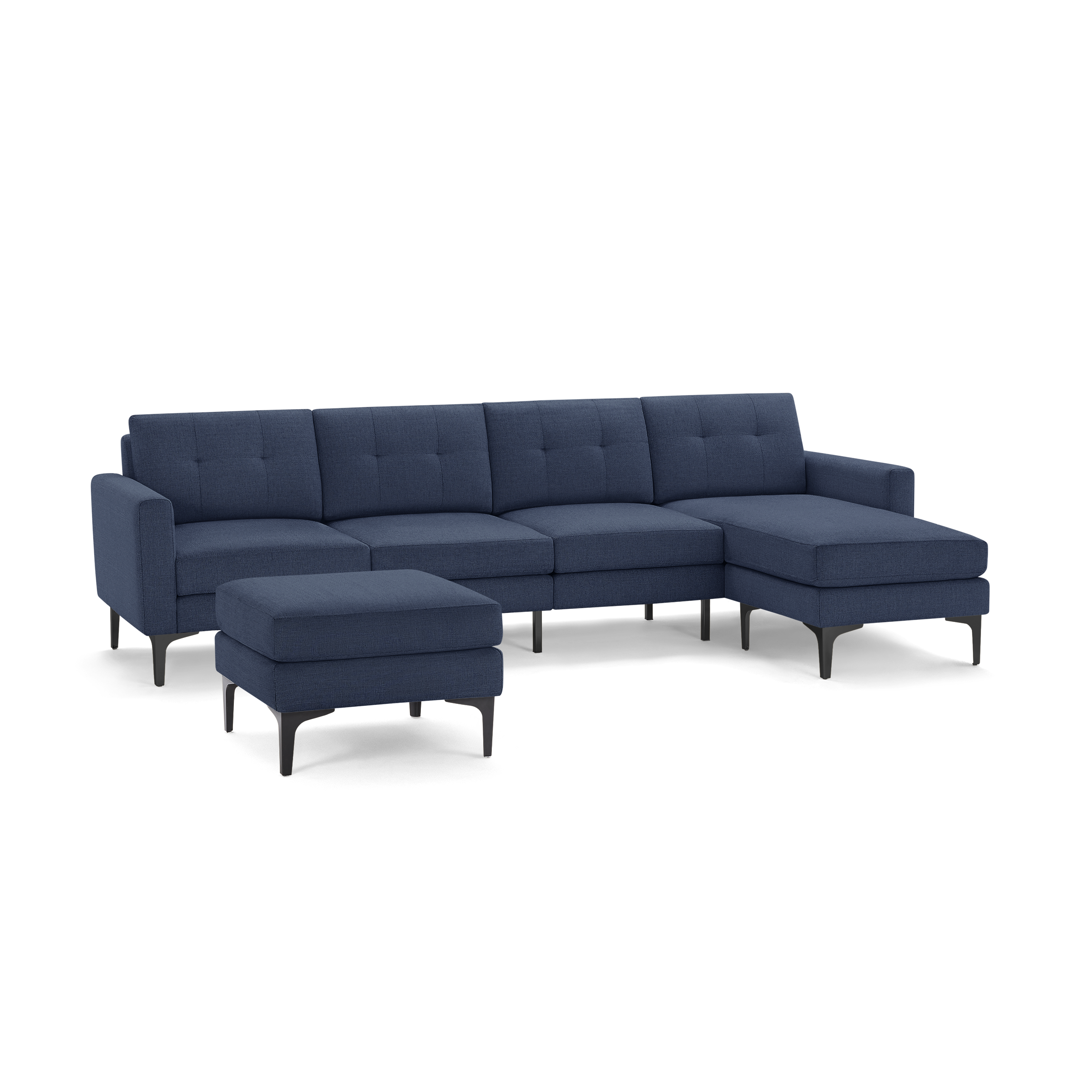 Modern navy blue fabric sectional sofa with chaise lounge and matching ottoman, featuring tufted cushions and black angled legs.