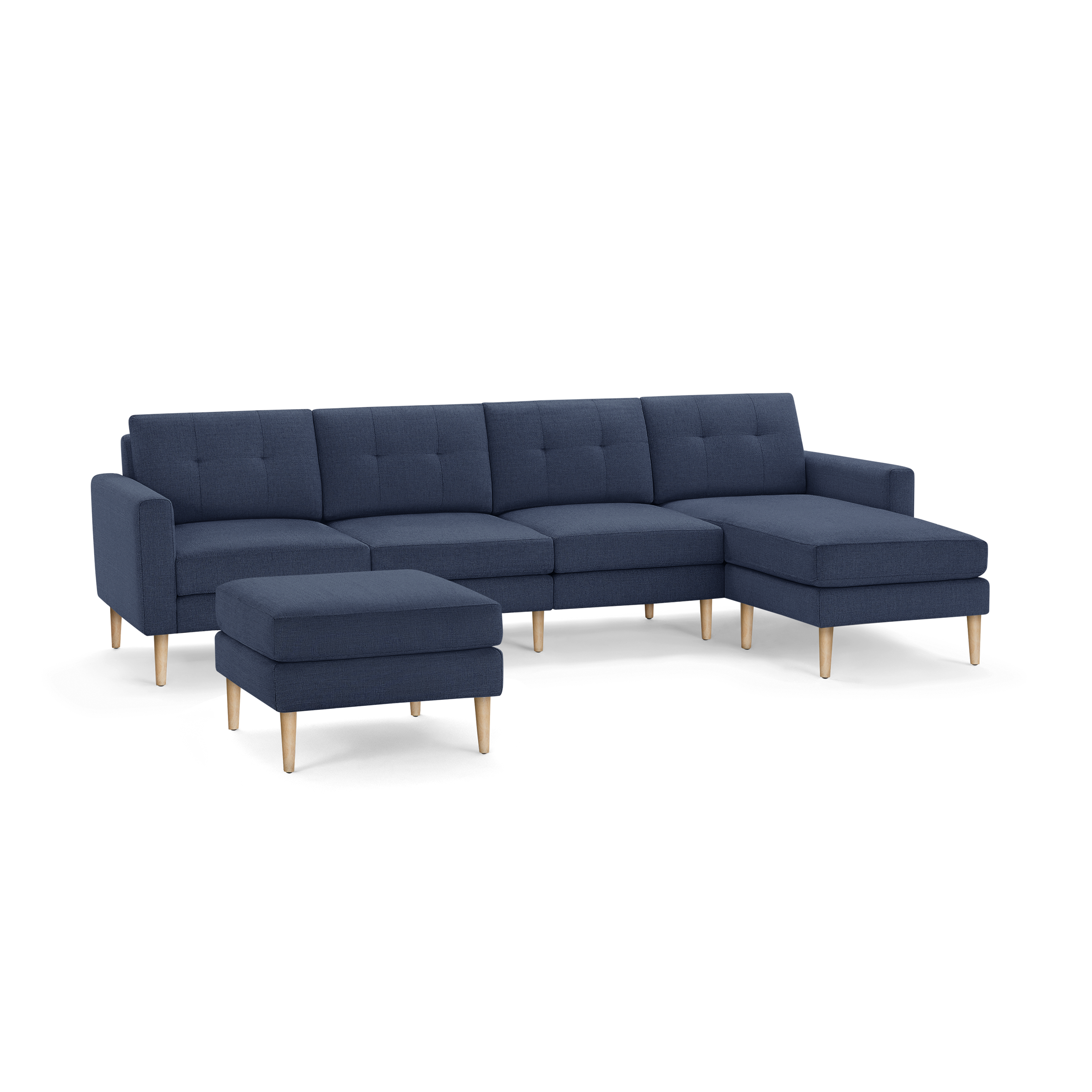 Blue fabric sectional sofa with wooden legs and matching ottoman, featuring tufted cushions and a right chaise lounge.