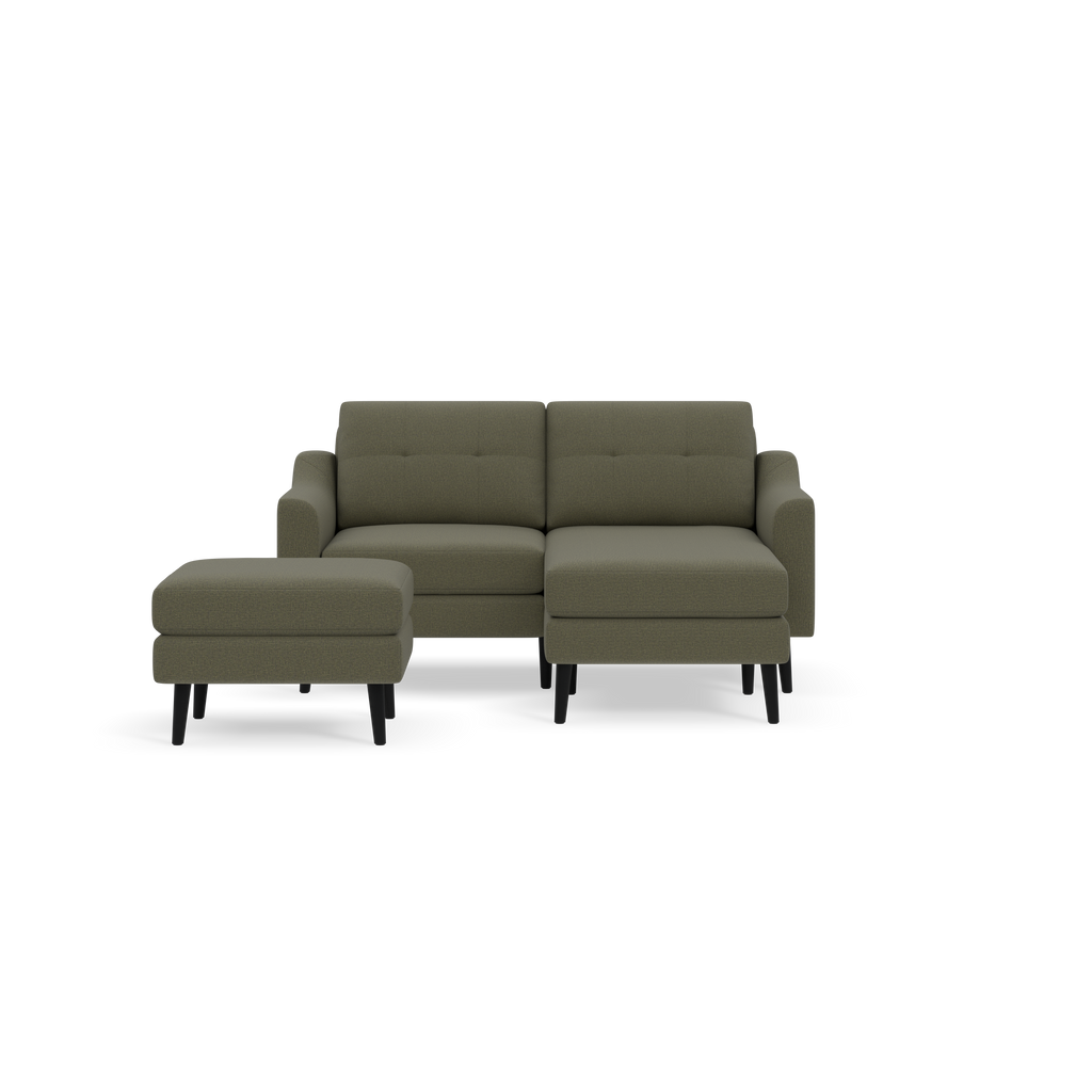 Modern Moss green fabric sectional sofa with attached ottoman, tufted back cushions, and dark wooden legs on a black background.