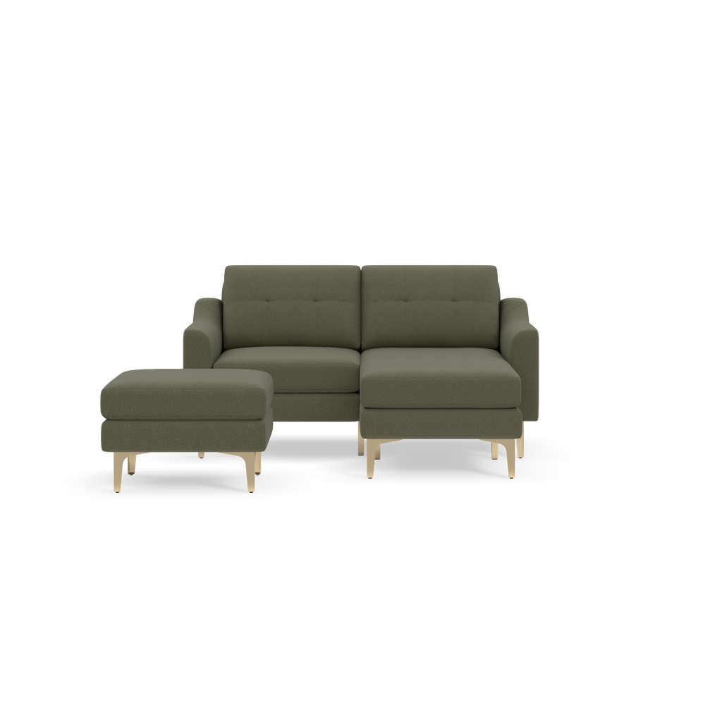 Moss green modern two-seater sofa with matching ottoman, featuring tufted cushions and light wooden legs, isolated on black background.
