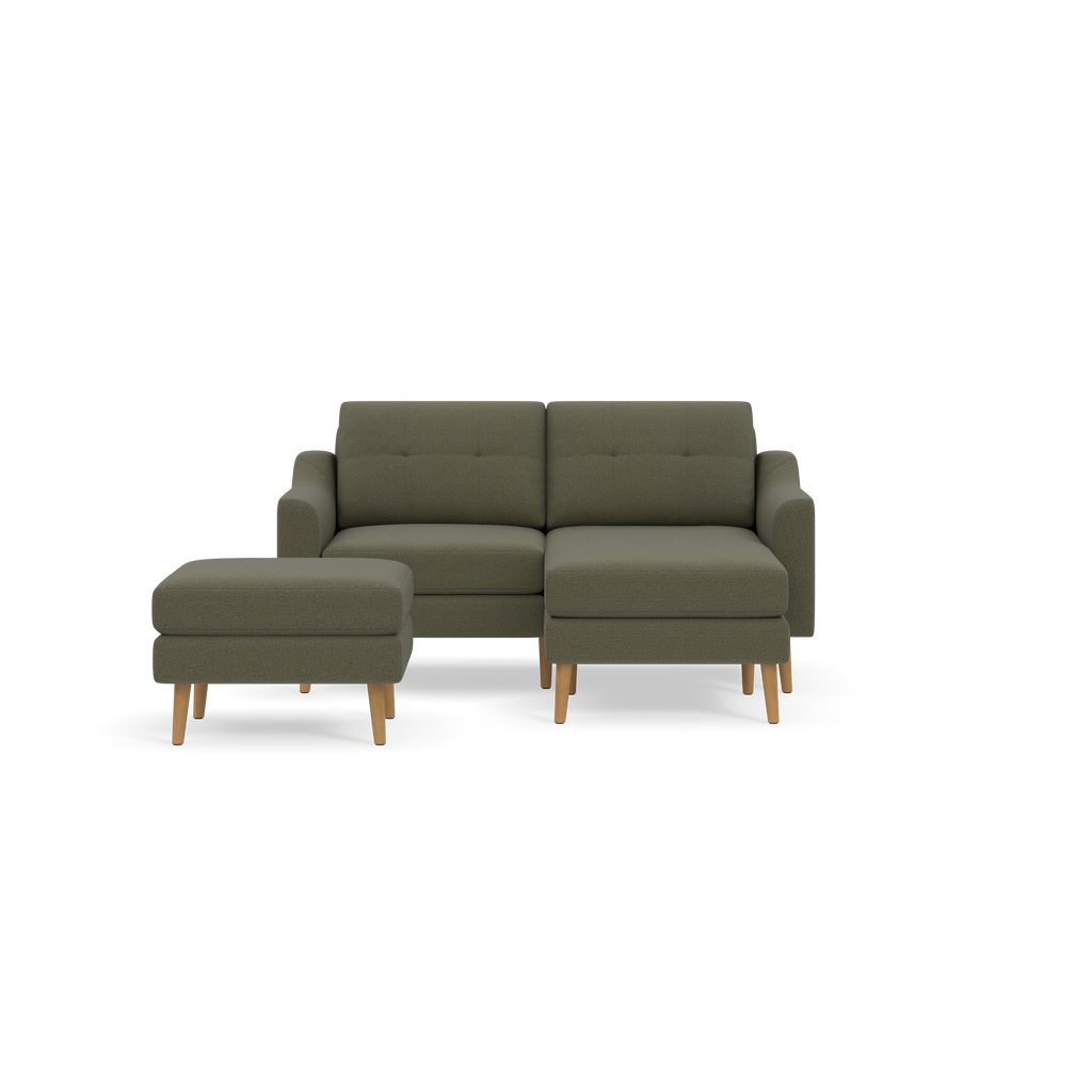 Dark Moss green modern sectional sofa with matching ottoman, wooden legs, tufted back cushions, clean lines on black background.