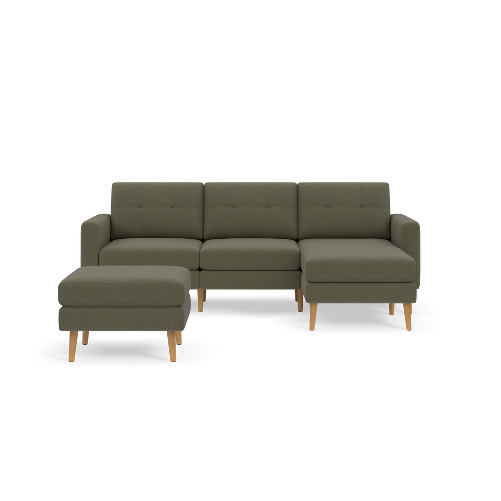 Modern Moss green fabric sectional sofa with tufted back cushions and matching ottoman, supported by light wooden legs.