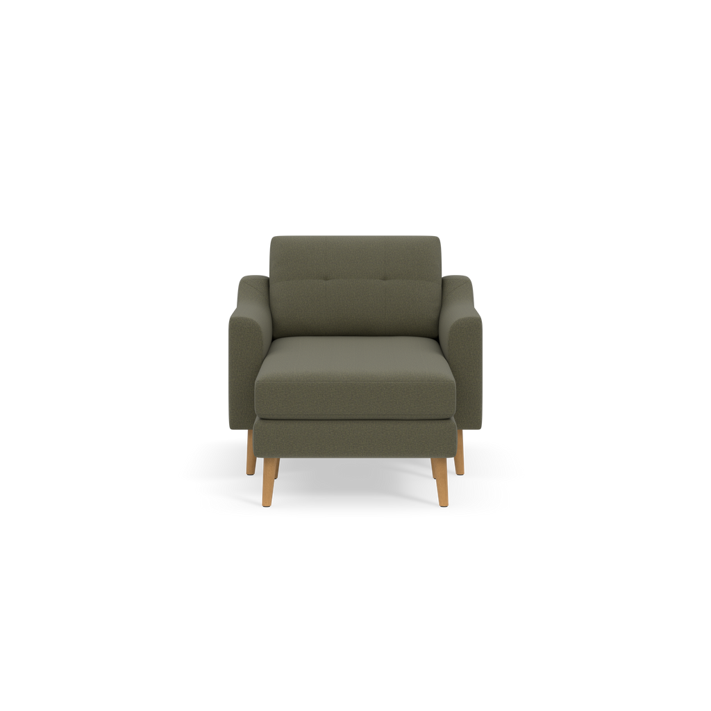 Front view of a modern, Moss green upholstered armchair with wooden legs and padded armrests against a black background.