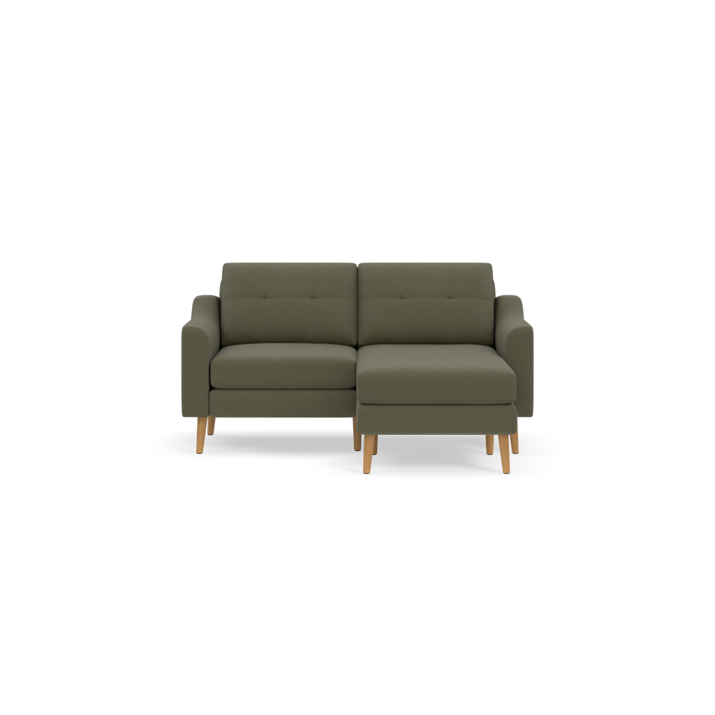 Moss green modern sectional sofa with tufted back cushions, wooden legs, and right-side chaise lounge.