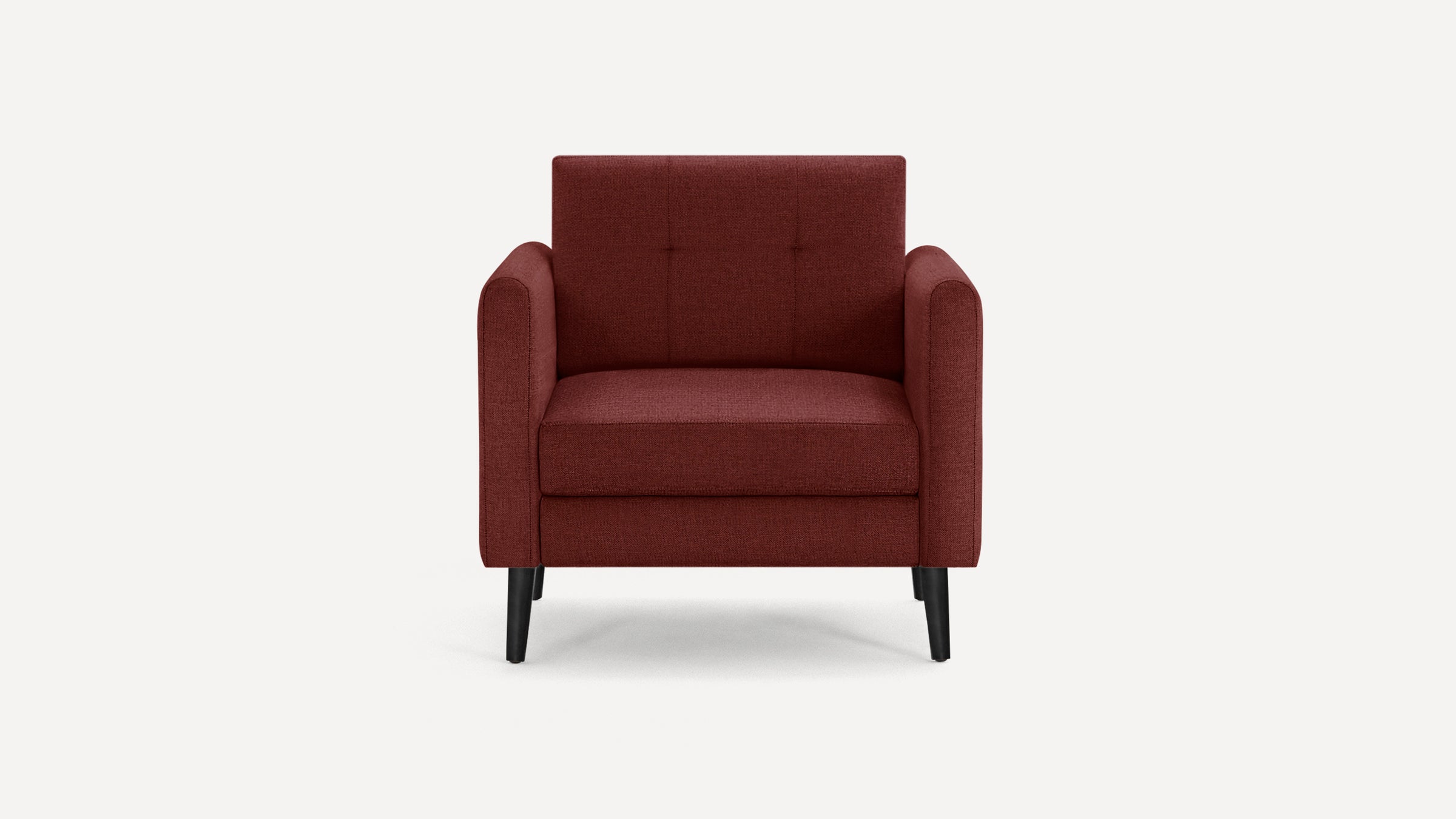 Front view of a modern, deep red upholstered armchair with square arms and black tapered legs on a white background.