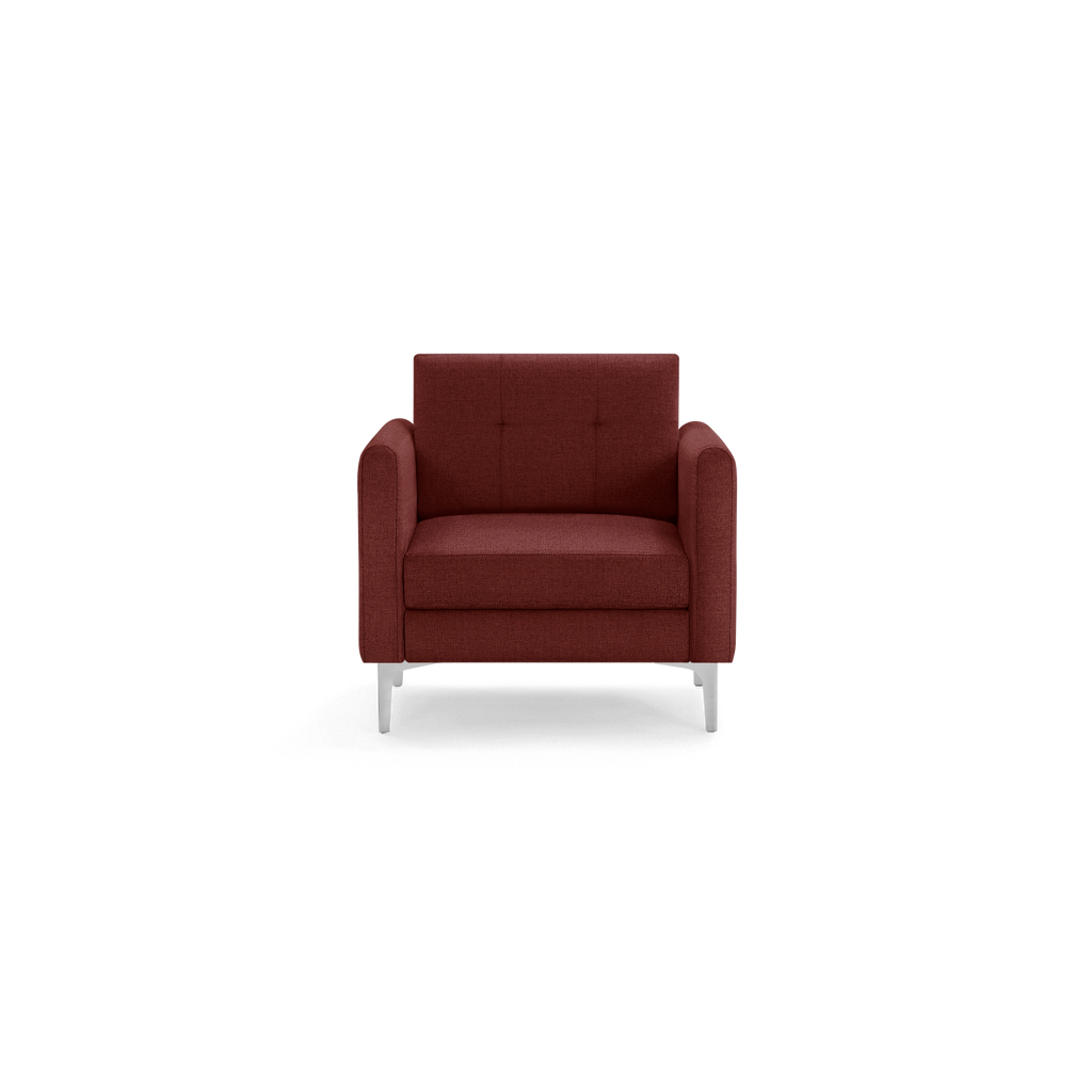 Front view of a modern, deep red upholstered armchair with square arms and silver legs on black background.