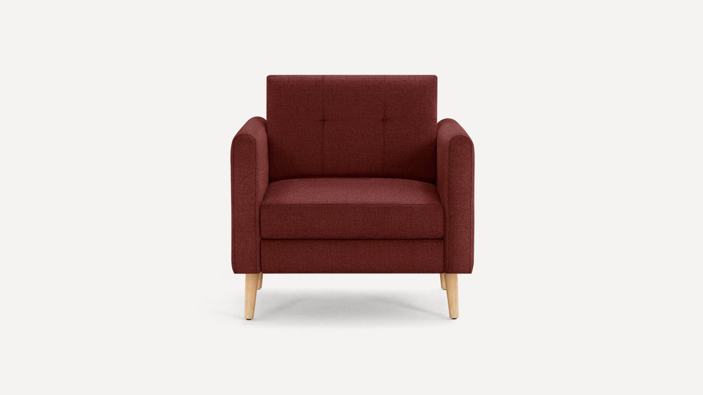 Front-facing maroon upholstered armchair with wooden legs and tufted backrest on plain white background.