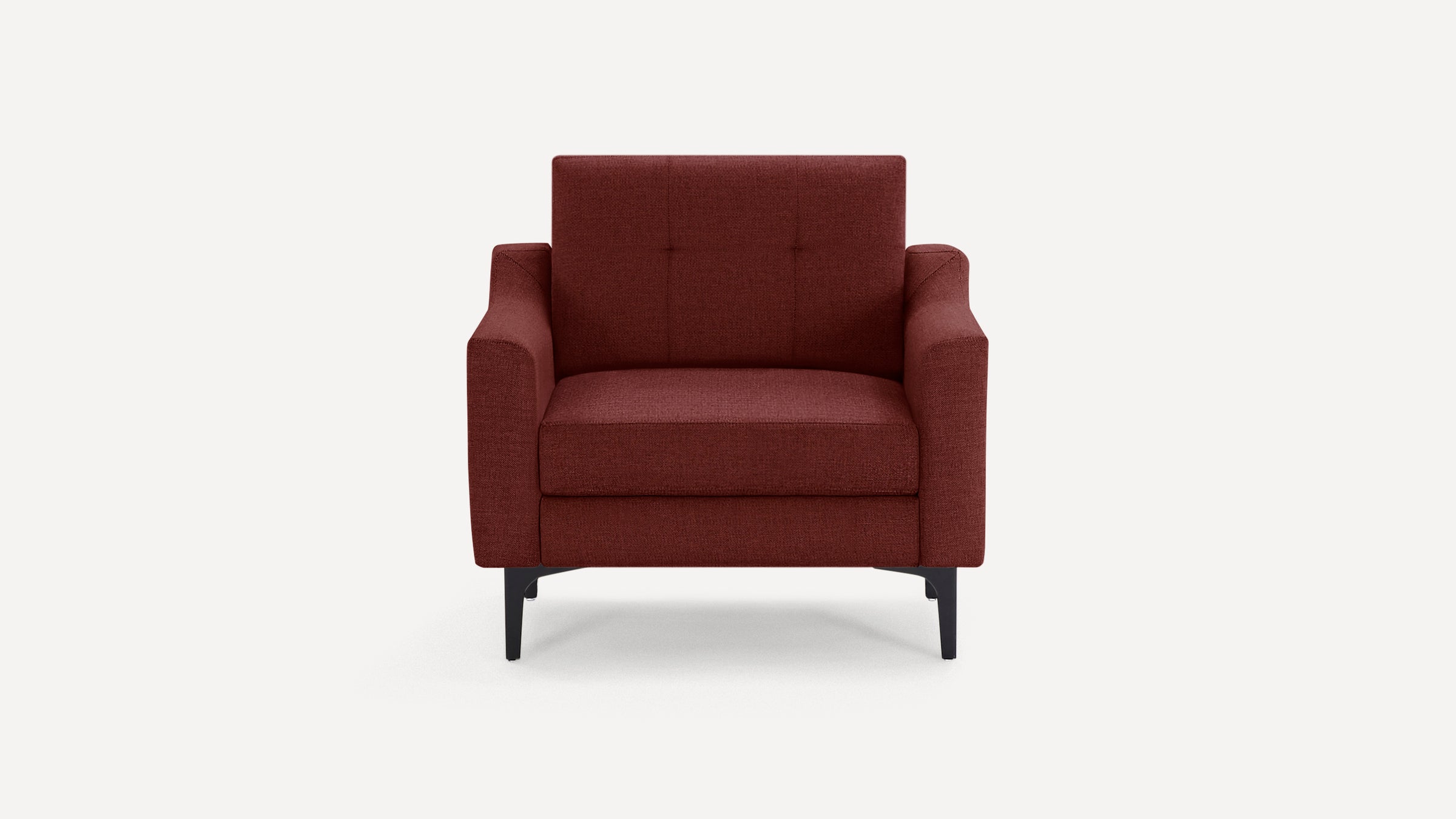 Modern armchair upholstered in deep red fabric with cushioned seat, tufted backrest, and black angled legs.