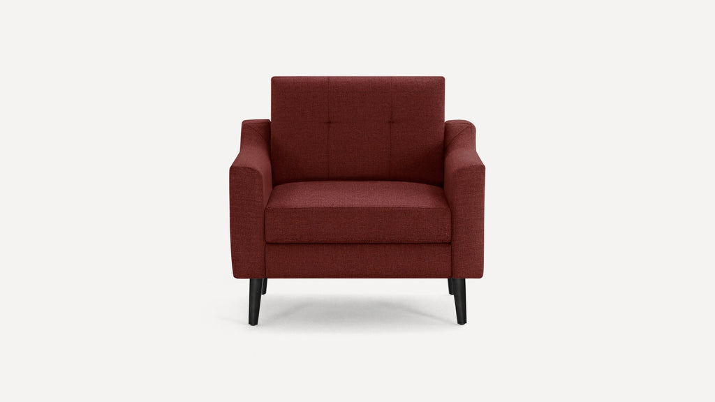 Front view of a modern burgundy upholstered armchair with black tapered legs and simple tufted backrest.