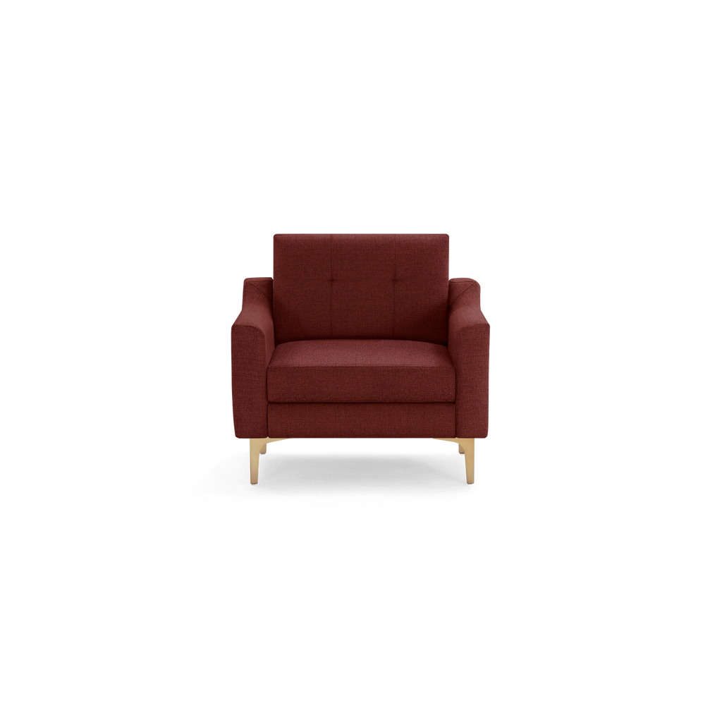 Front view of a modern, deep red upholstered armchair with tufted backrest and light wooden legs.