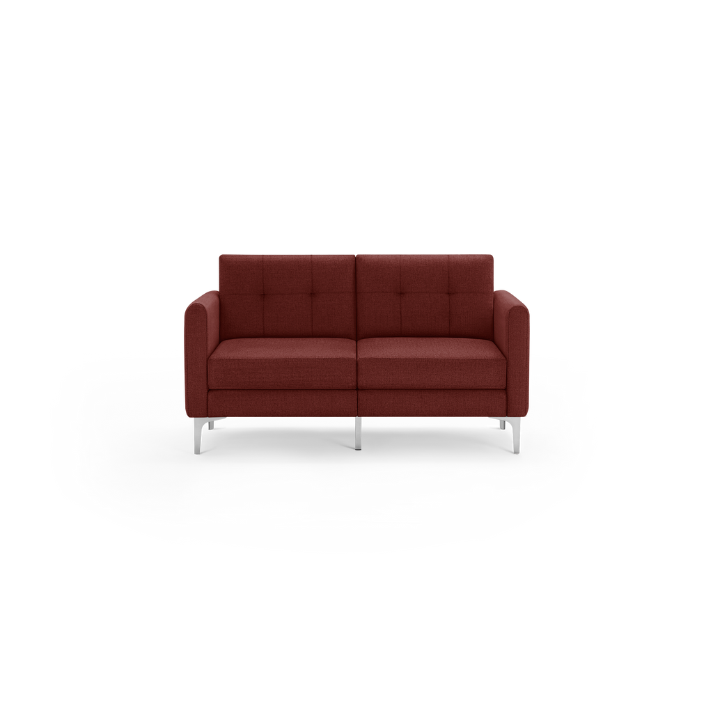 Modern two-seater sofa in dark red fabric with square tufted back cushions, box seat cushions, rounded armrests, and slim silver metal legs.