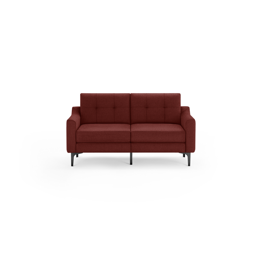 Modern two-seater sofa in deep rust red fabric with tufted backrest, cushioned seats, and sleek black metal legs.