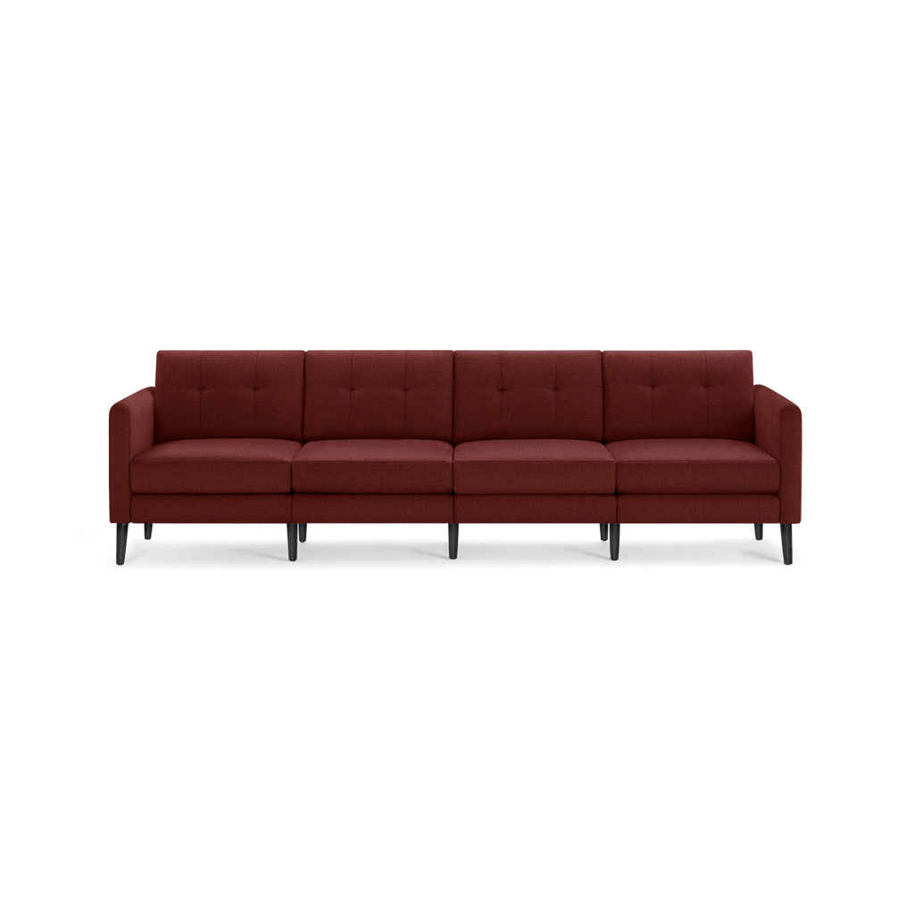 Four-seat, mid-century modern sofa upholstered in textured deep red fabric with tufted back cushions and black tapered wooden legs.