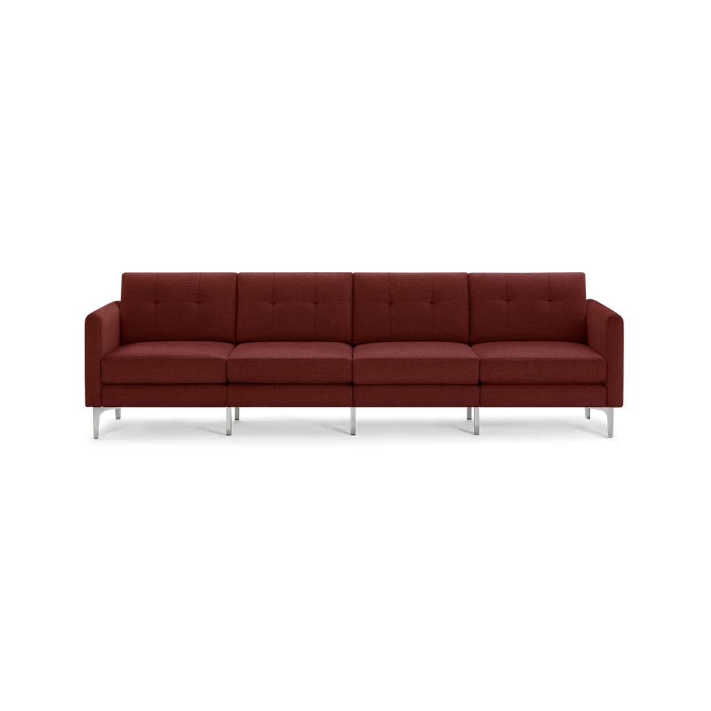 Four-seater modern sofa in deep rusty red fabric with tufted back cushions and sleek silver metal legs.