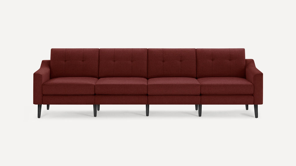 Four-seater modern sofa with deep red fabric upholstery, tufted back cushions, and black tapered wooden legs on a white background.