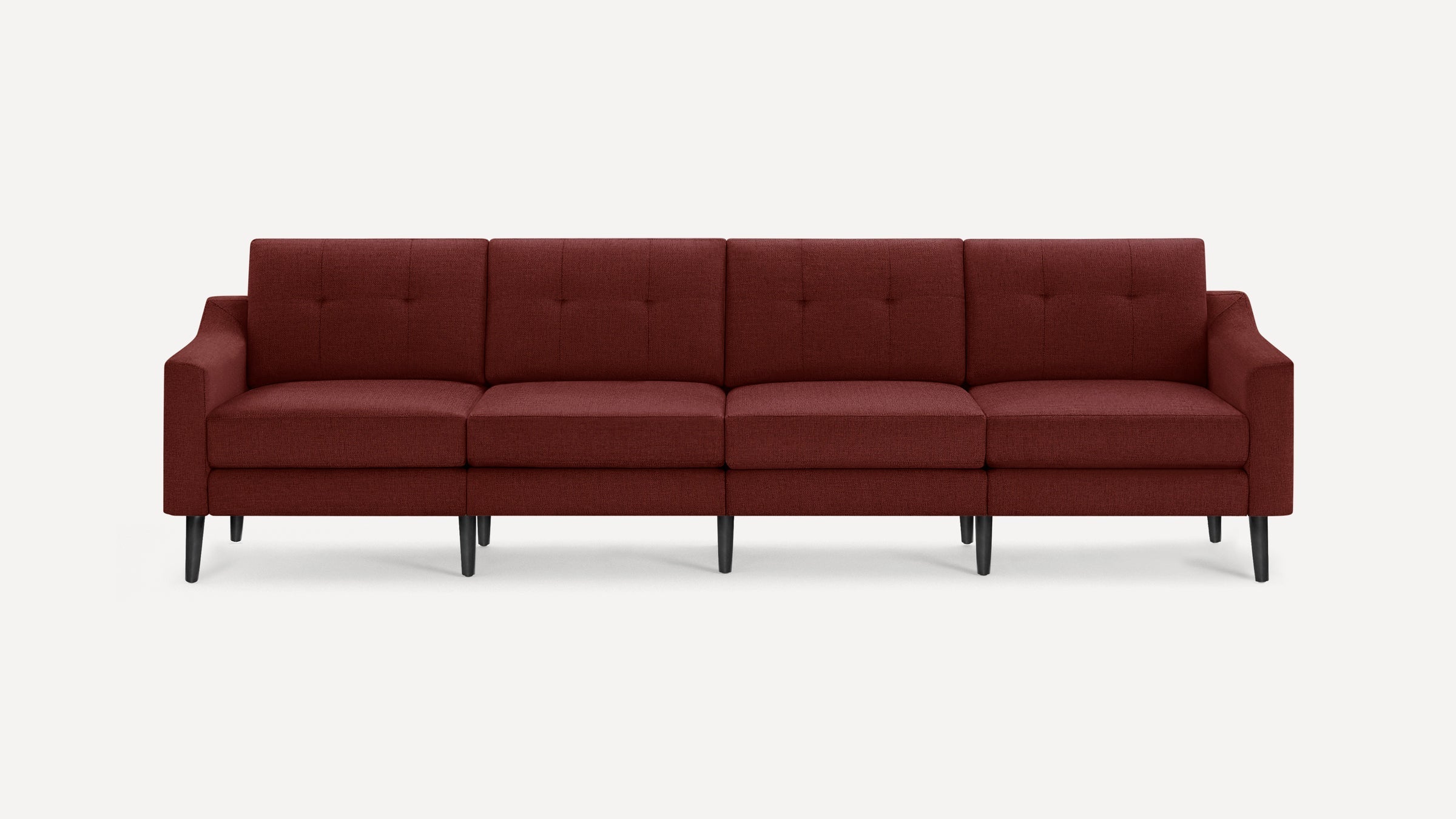 Four-seater modern sofa with deep red fabric upholstery, tufted back cushions, and black tapered wooden legs on a white background.