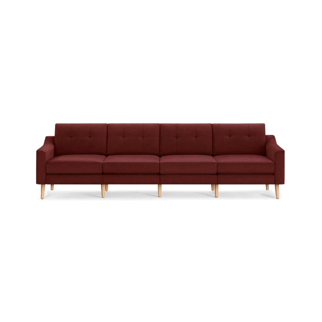 Four-seater modern sofa upholstered in burgundy fabric with wooden legs and tufted back cushions, designed for living room comfort.