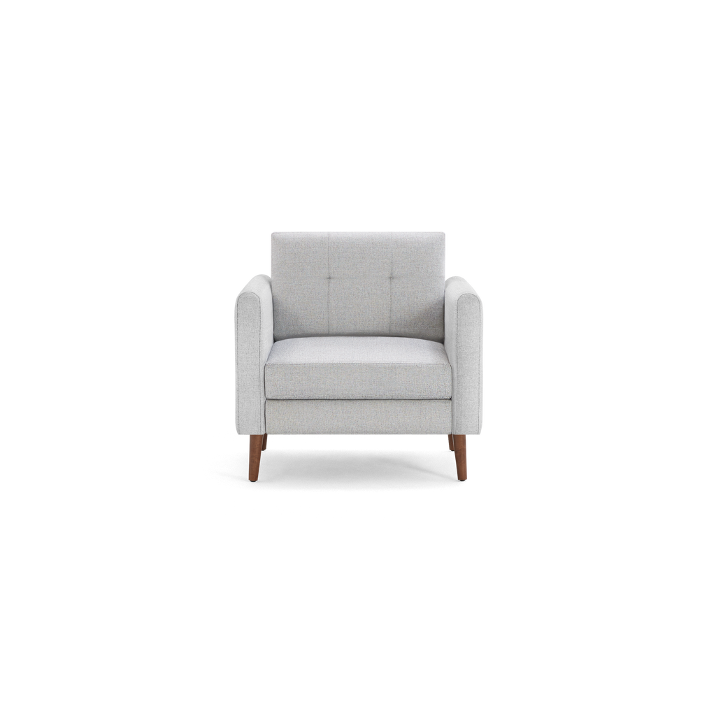 Modern light gray upholstered armchair with tufted backrest and wooden legs, featuring broad armrests for comfortable seating.