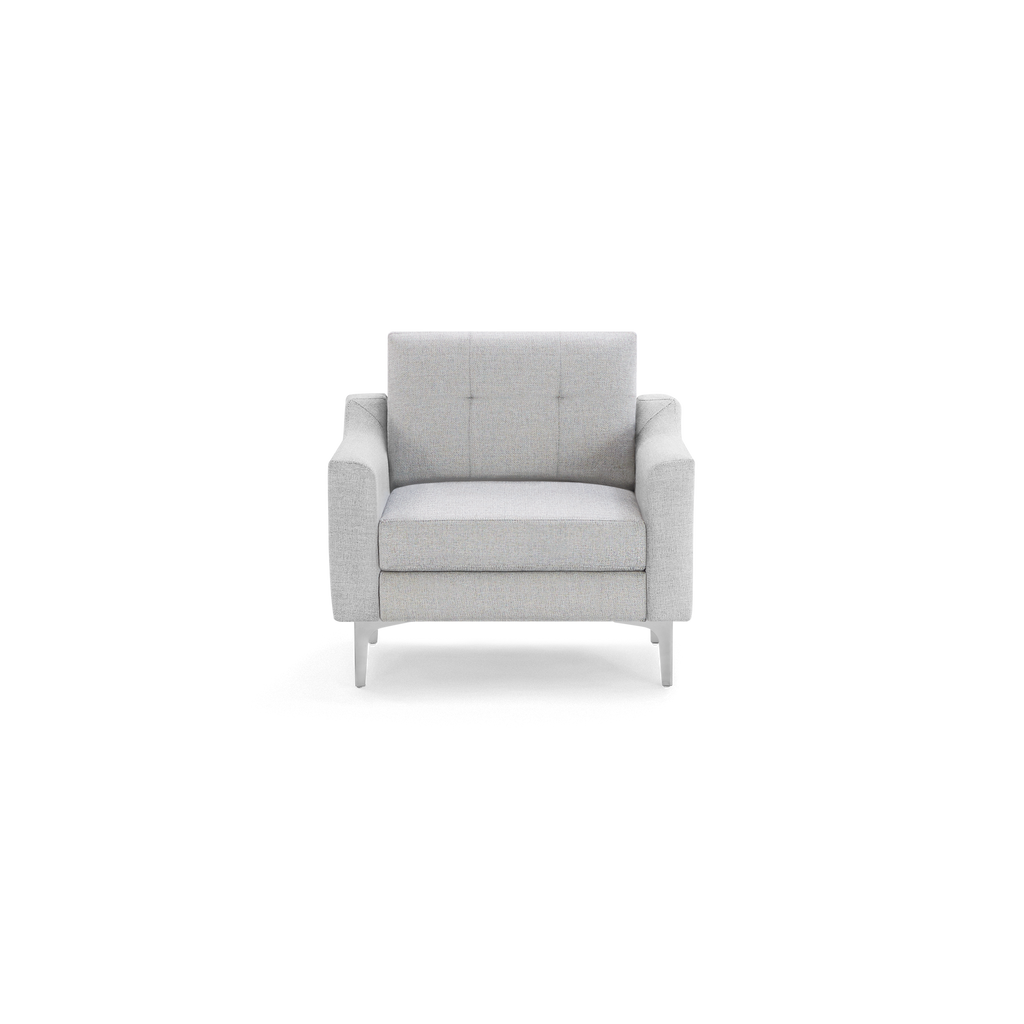 Modern light gray upholstered armchair with tufted backrest and sleek metal legs, shown against a black background.